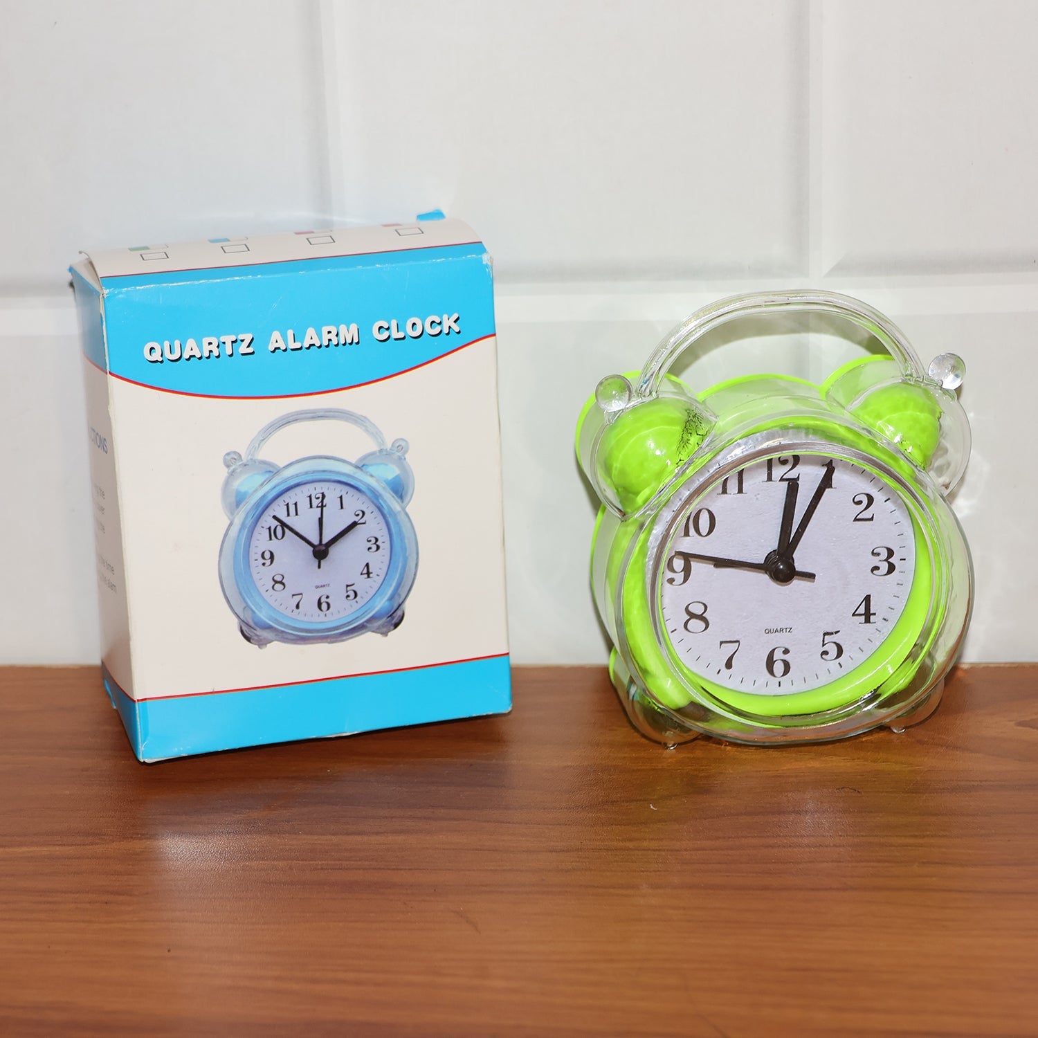Portable compact quartz analog alarm clock in green transparent frame
