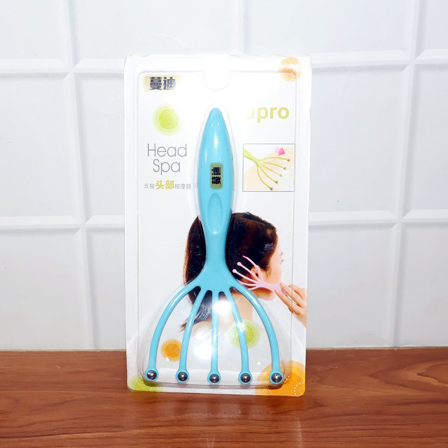 Five-finger head massager with rolling balls displayed on white background