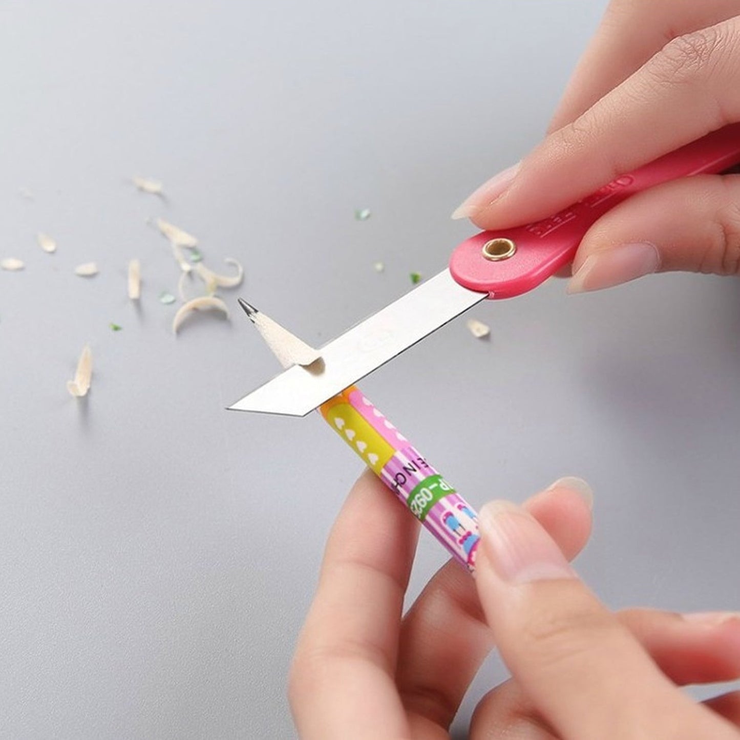 Vibrant multicolour handle of a mini paper cutter knife showing ergonomic design.