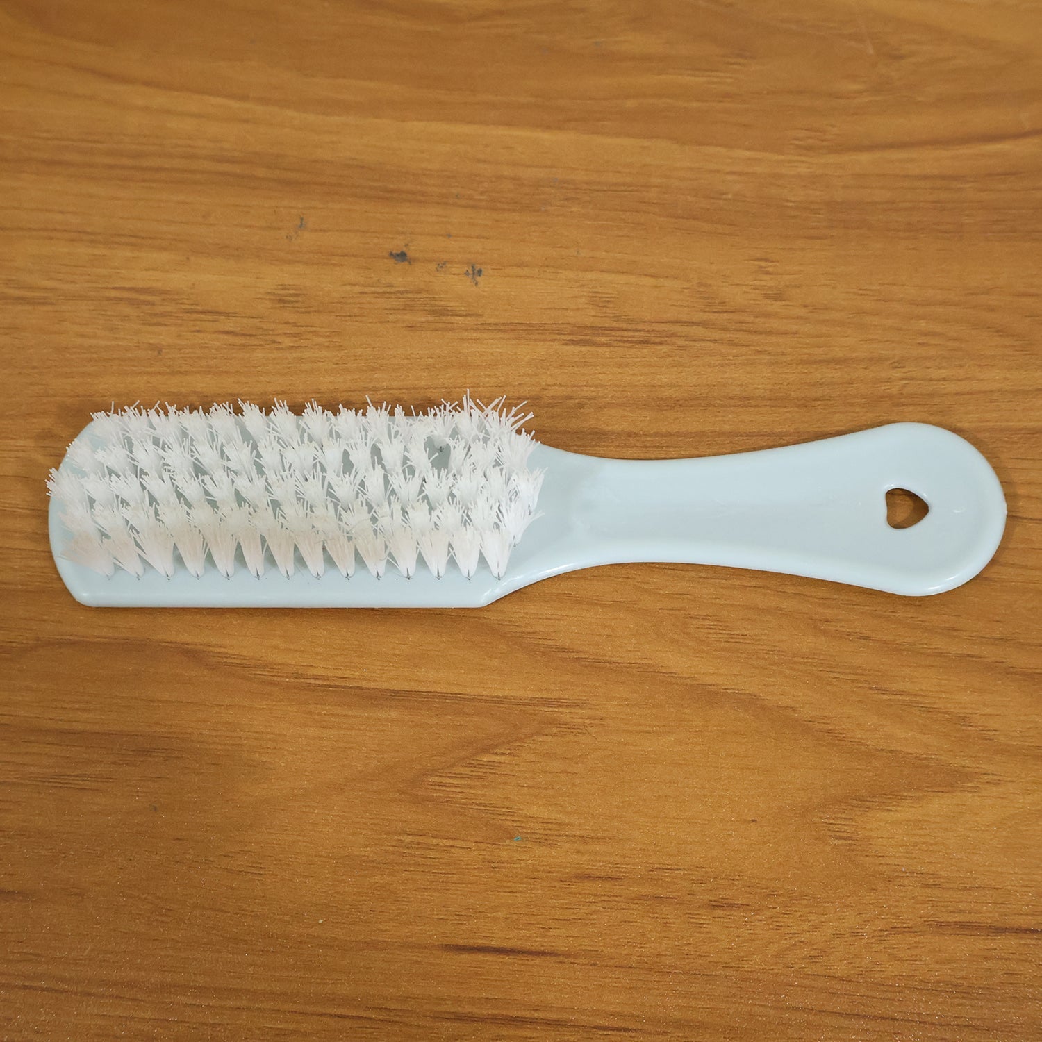 Close-up of ergonomic handle and bristles on handheld cleaning brush