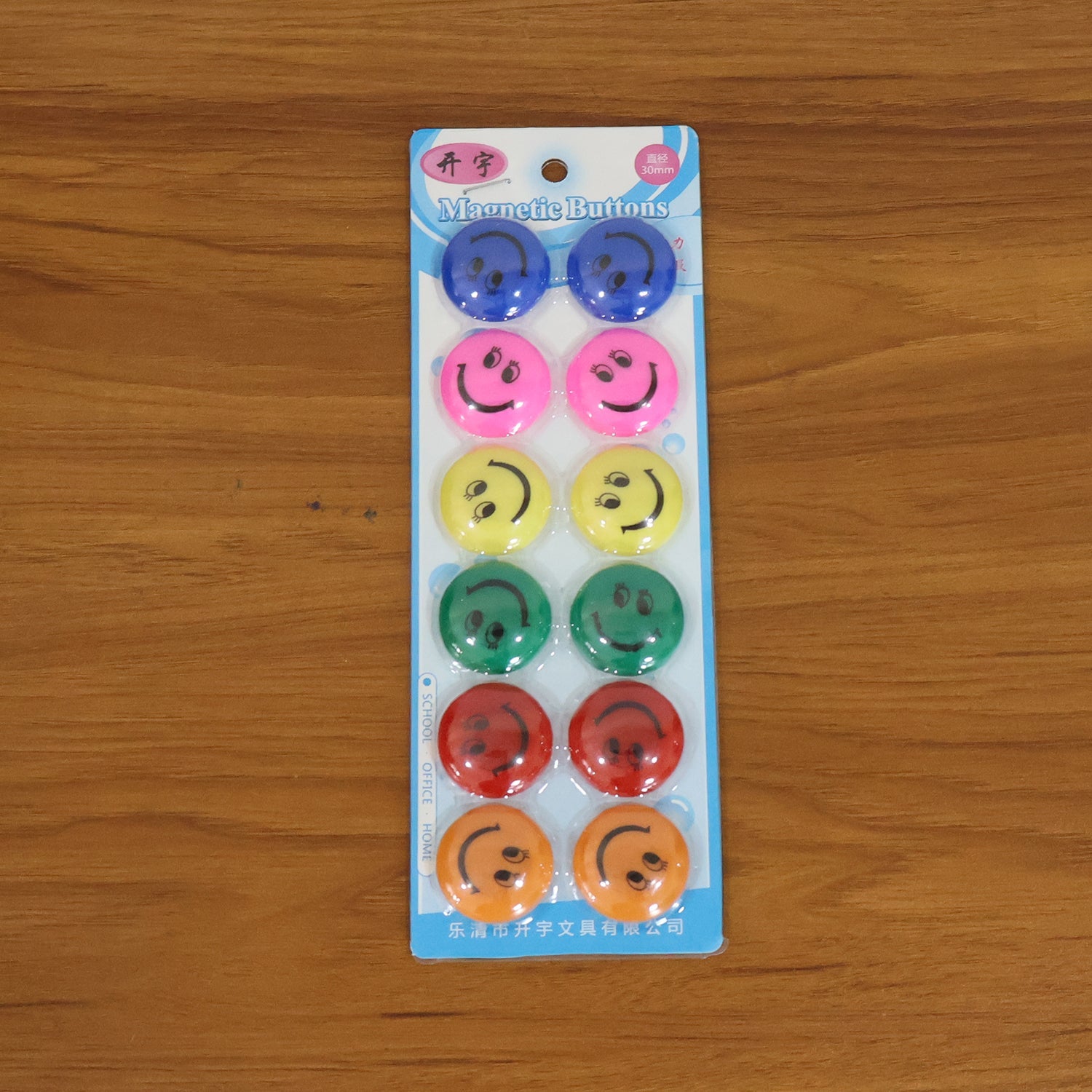 Multicolored smiley face magnetic buttons arranged in set