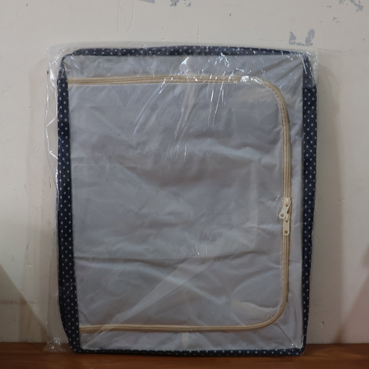 Multiple foldable steel-frame clothes storage boxes neatly stacked in a closet.