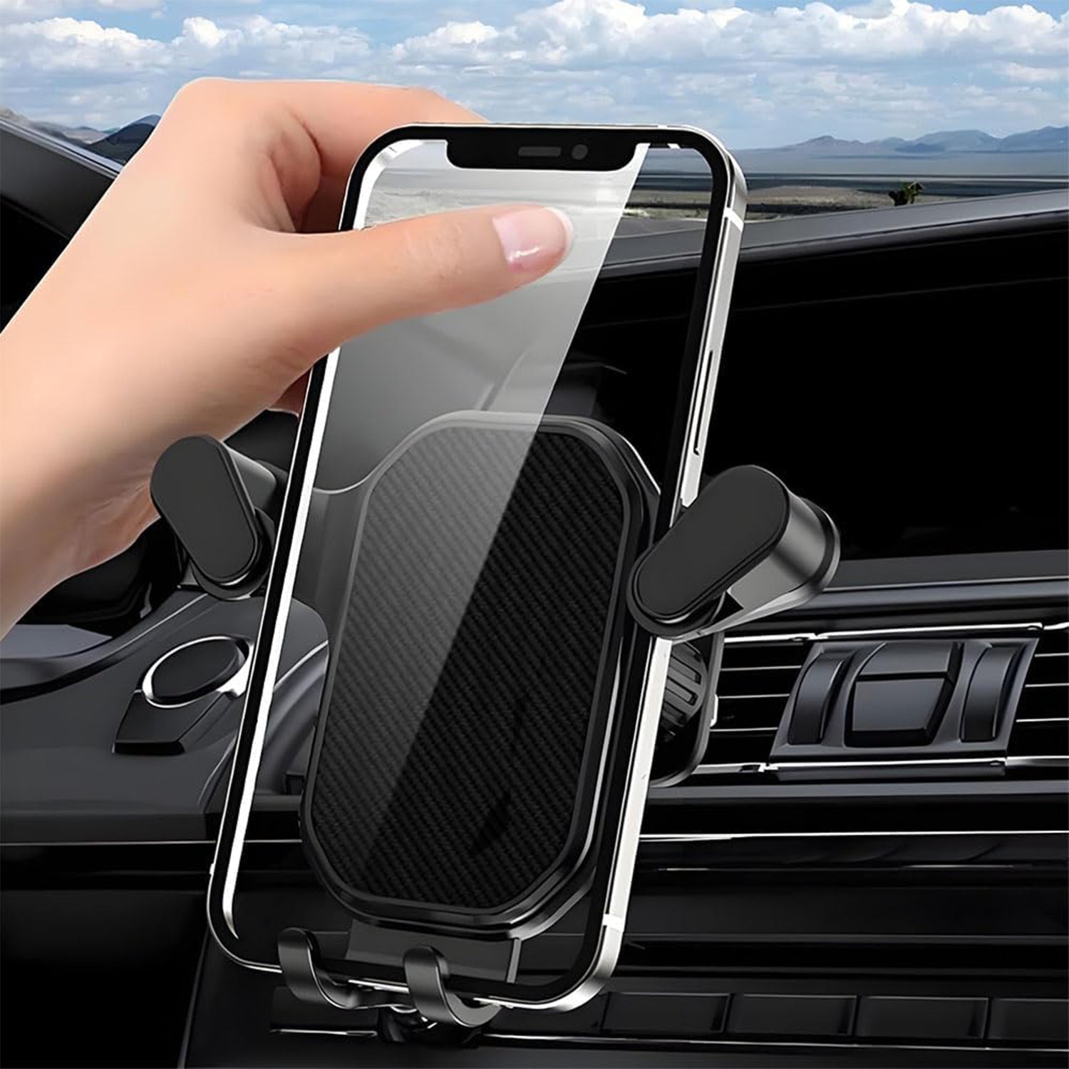 Black plastic car mobile holder mounted on AC air vent holding smartphone securely