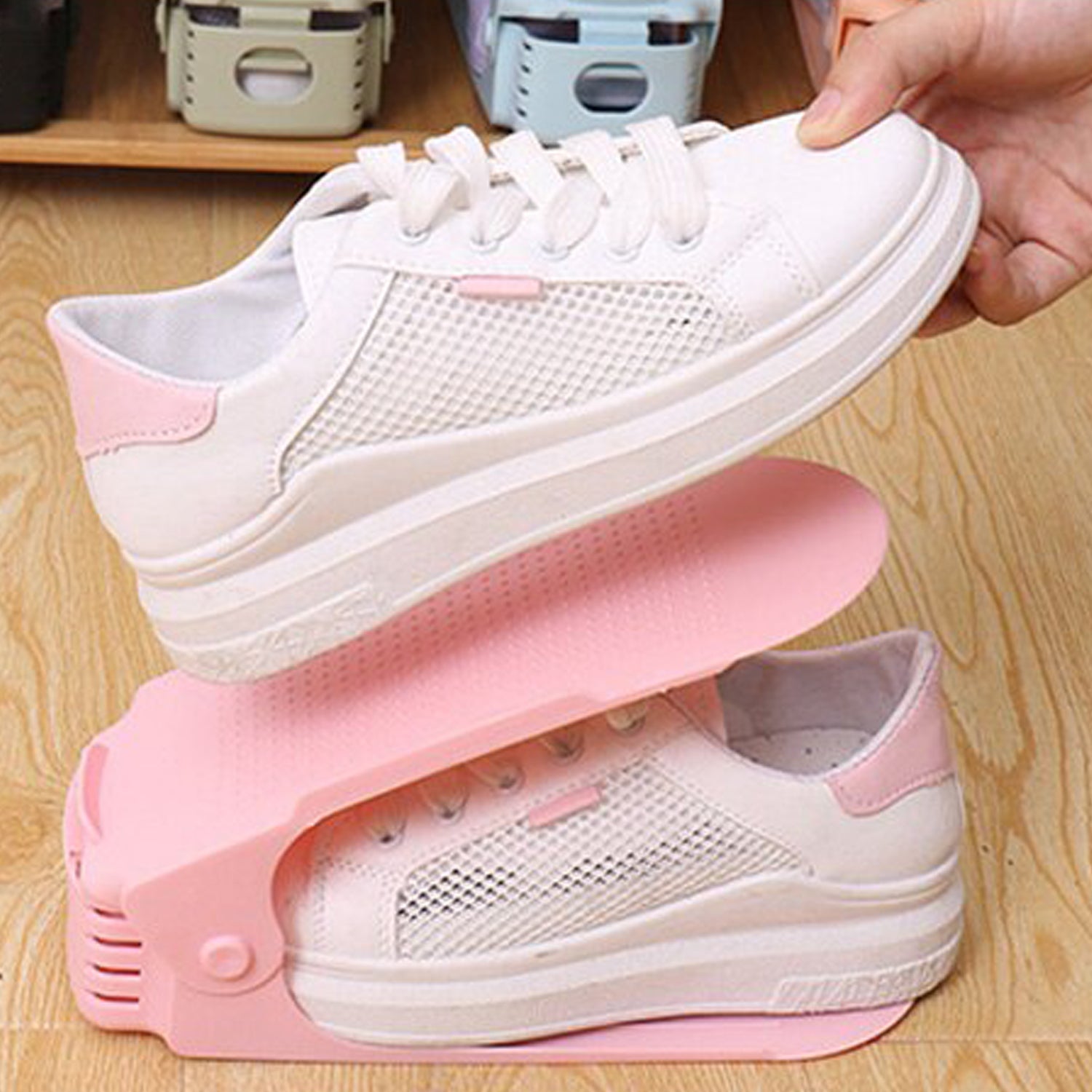 A multi-color adjustable shoe organizer neatly stacking a pair of sneakers.