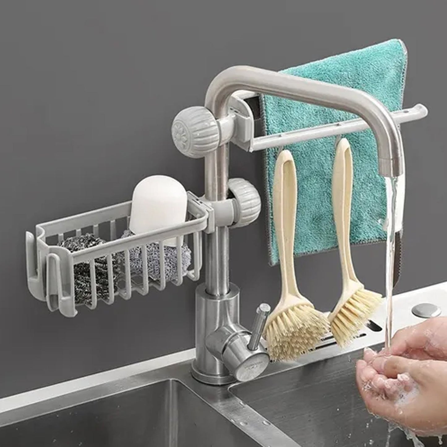 Sink organizer holding towels and brushes on faucet