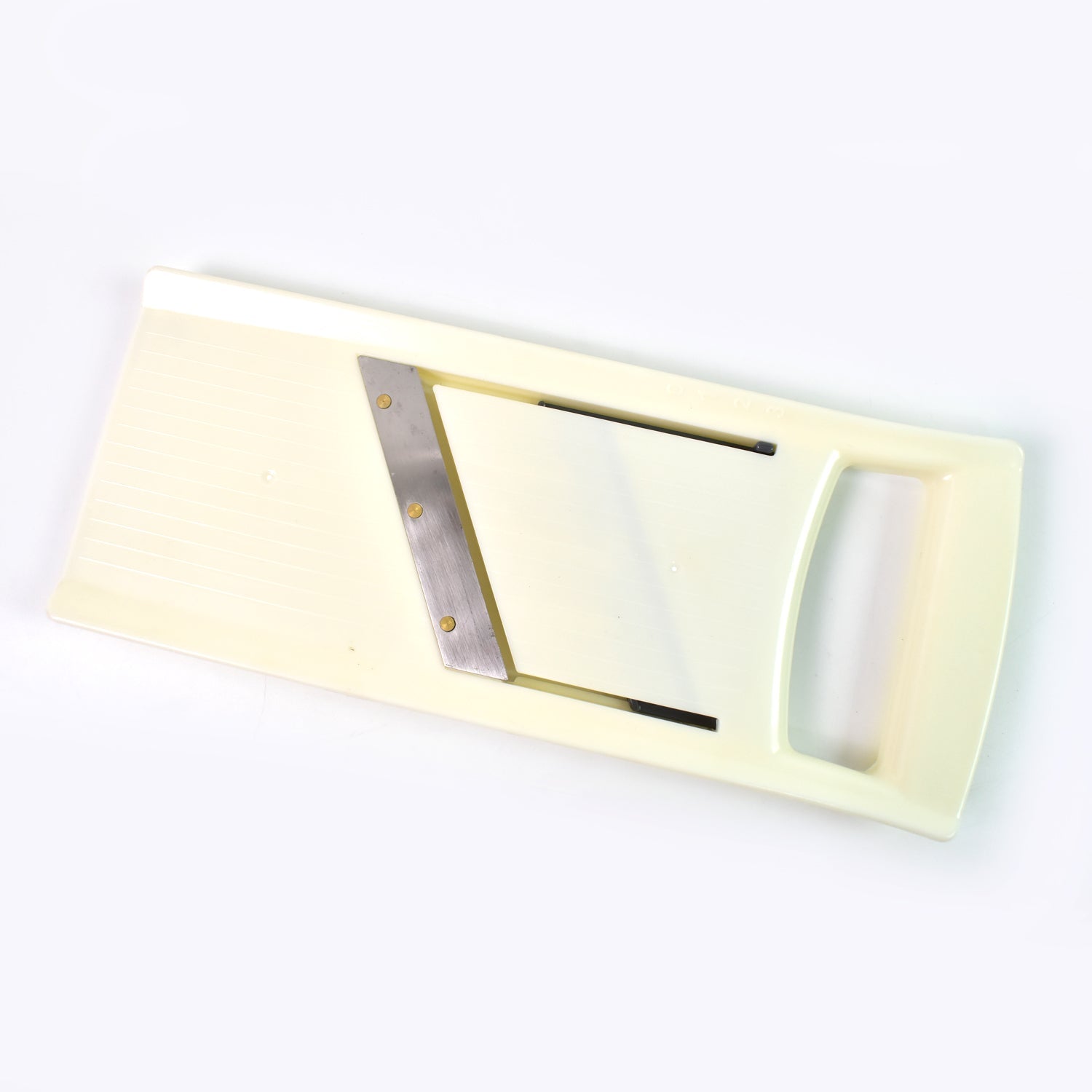 Close-up of the adjustable thickness control knob on the vegetable slicer.