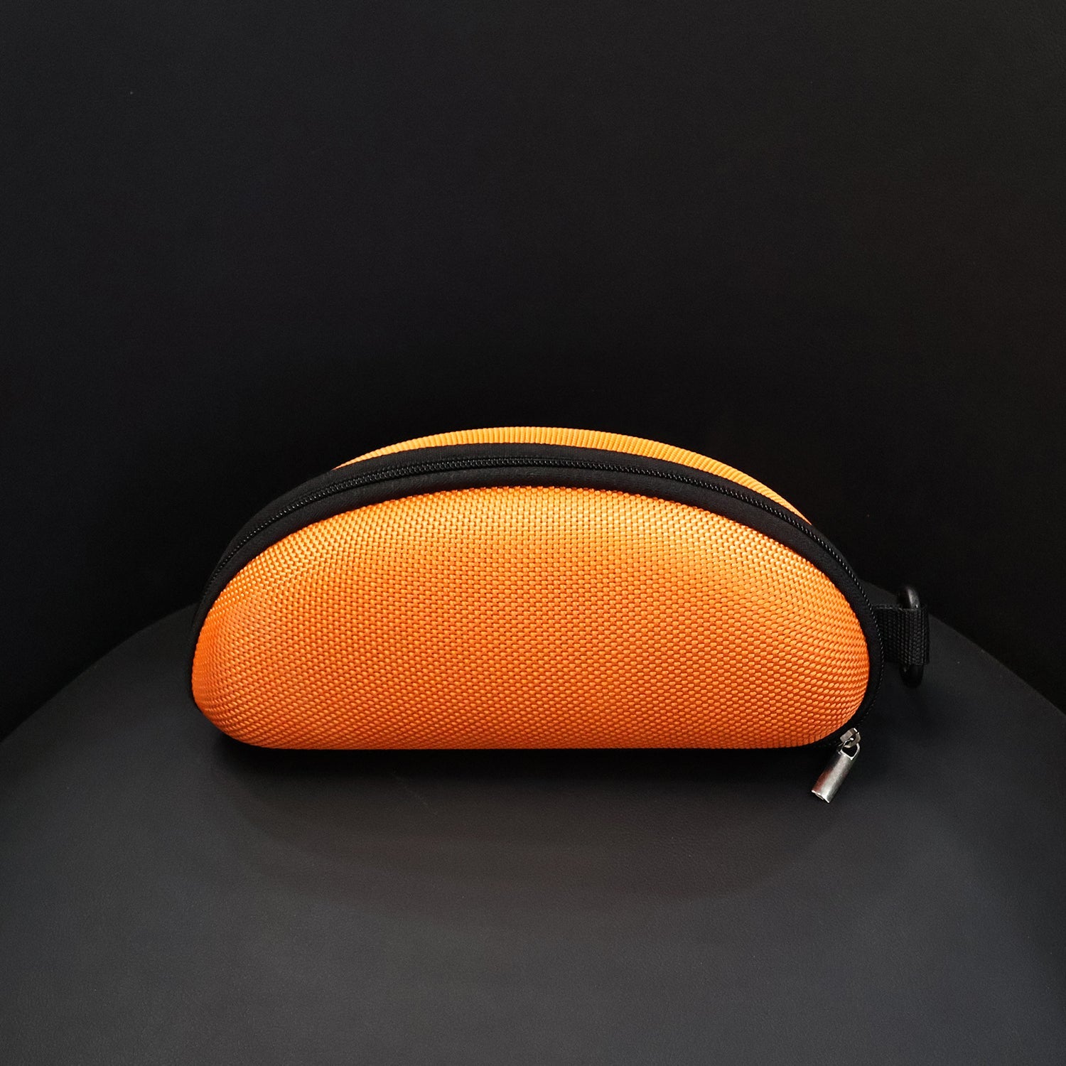 Multiple black zipper sunglasses cases stacked, indicating availability and compact storage.