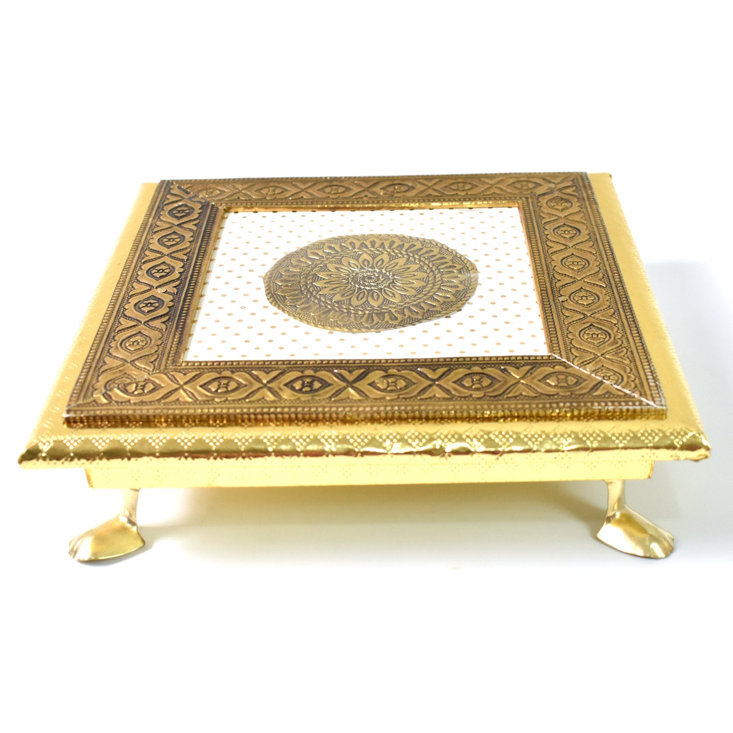 Detail shot of the golden Pooja Bajot featuring a delicate lotus motif.