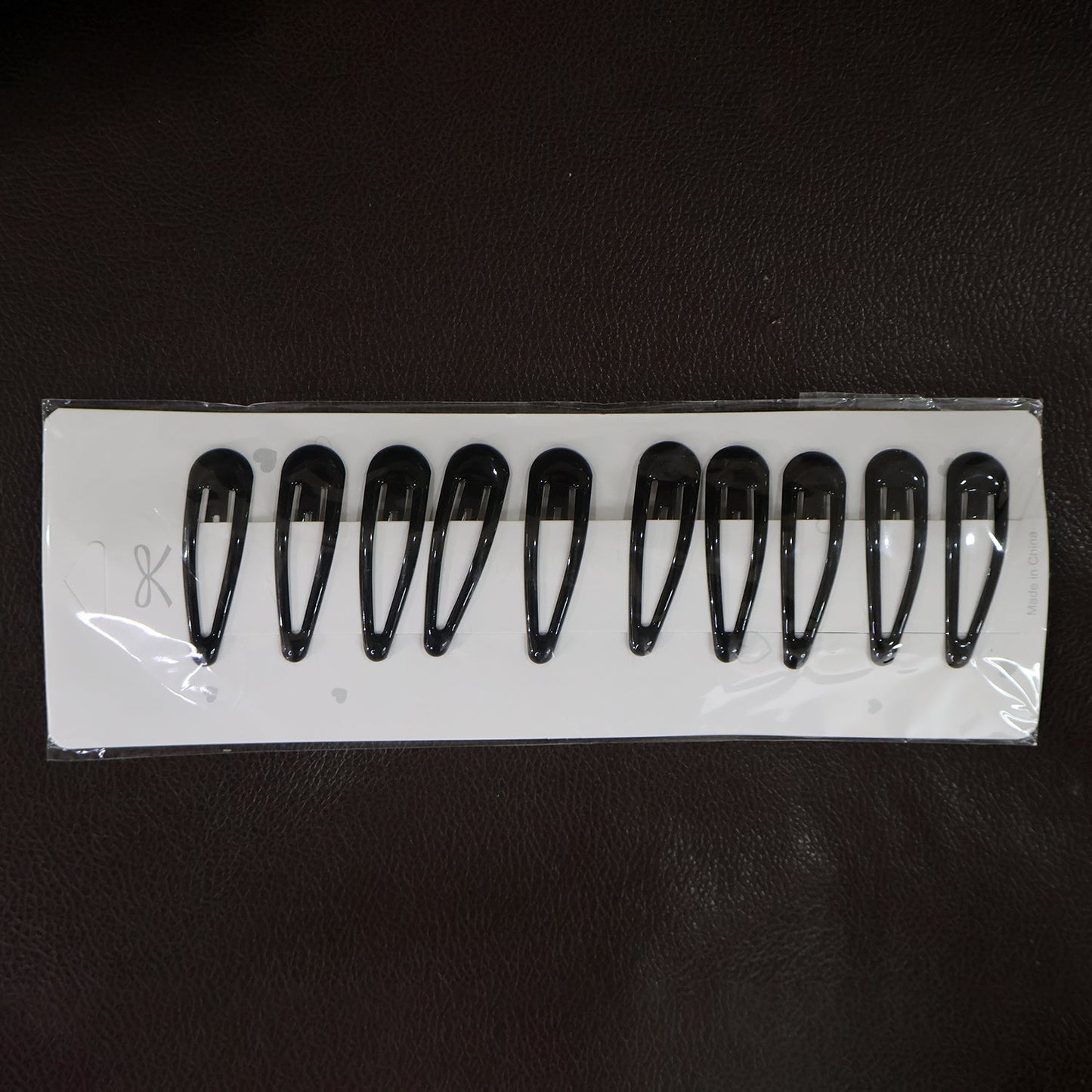 Matte finish metal hair clips held for size reference