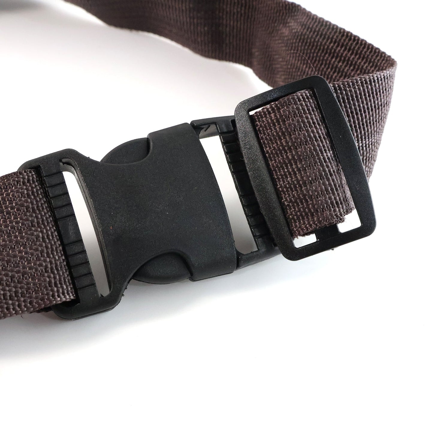 Brown canvas waist bag showing detailed zipper and leather accents