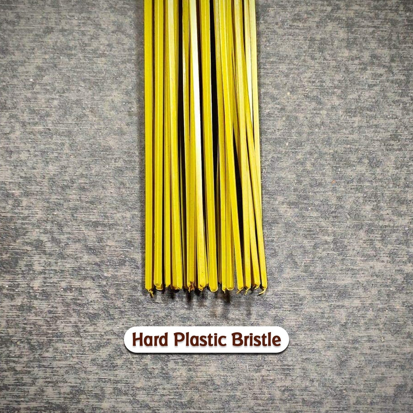 Detailed view of the hard bristles and plastic handle of the durable cleaning broom.
