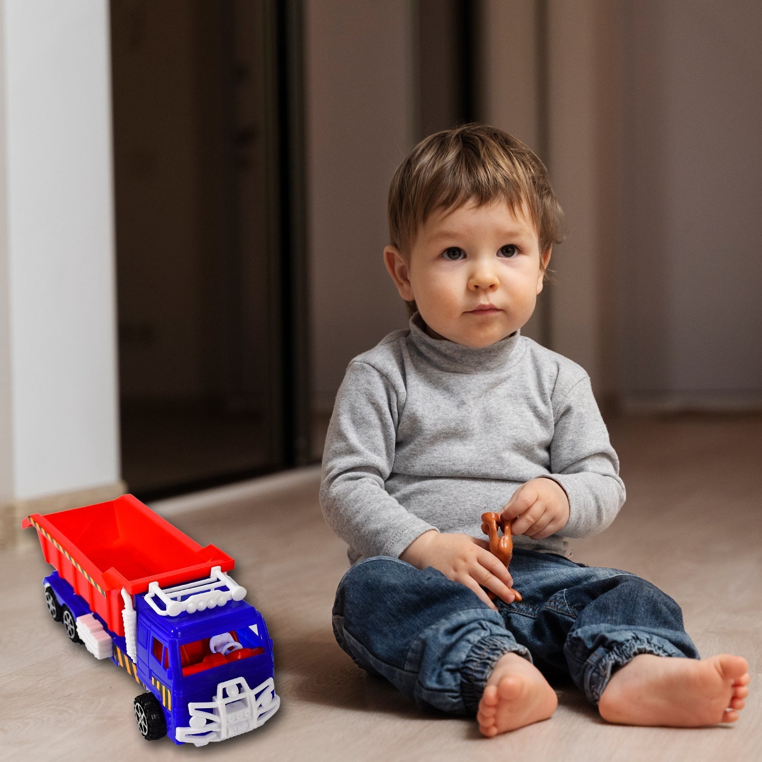 Children's hands playing with the non-toxic Friction Power Truck Toy.