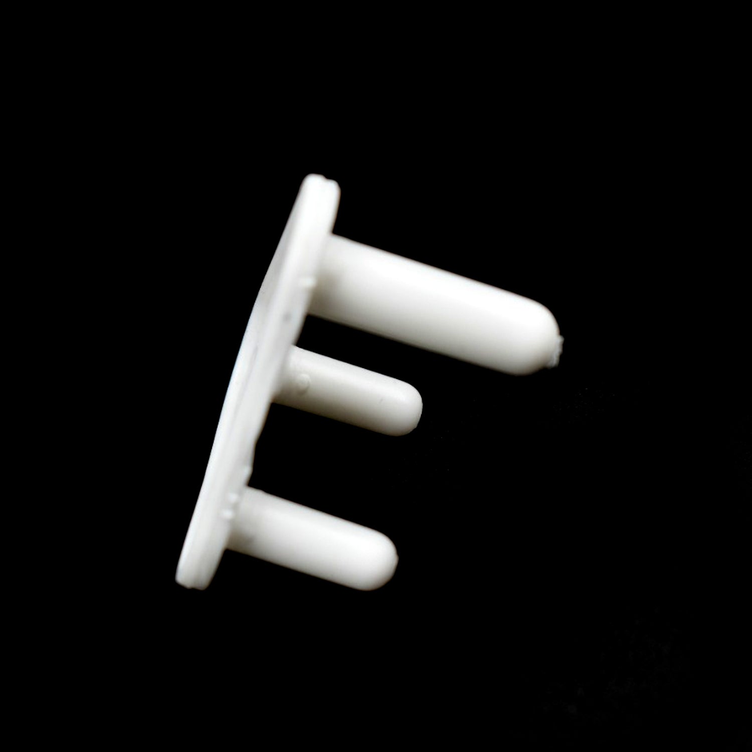 Pack of 100 white baby socket covers, essential for child safety in homes.