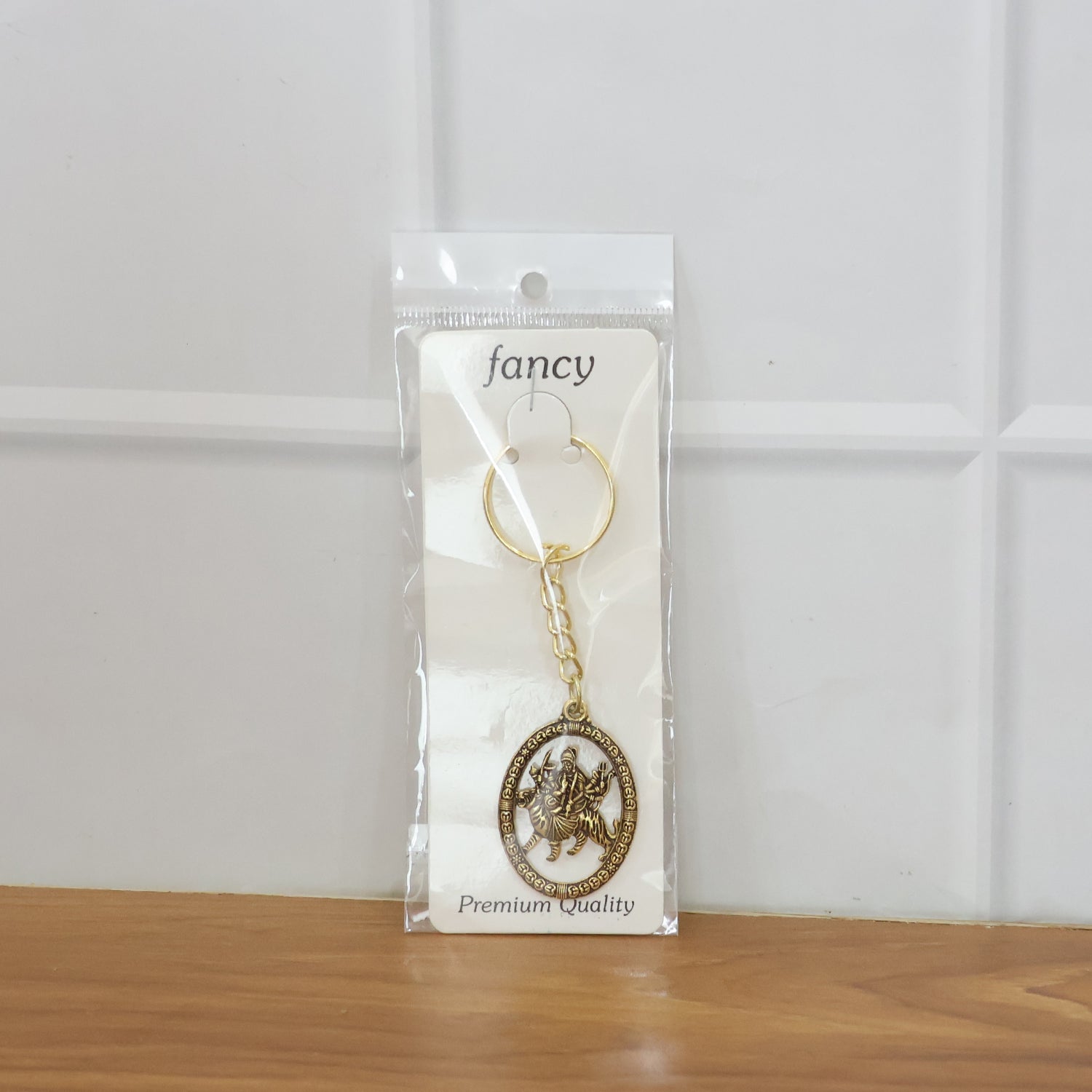 Detailed close-up of premium metal Durga Maa keychain with golden finish