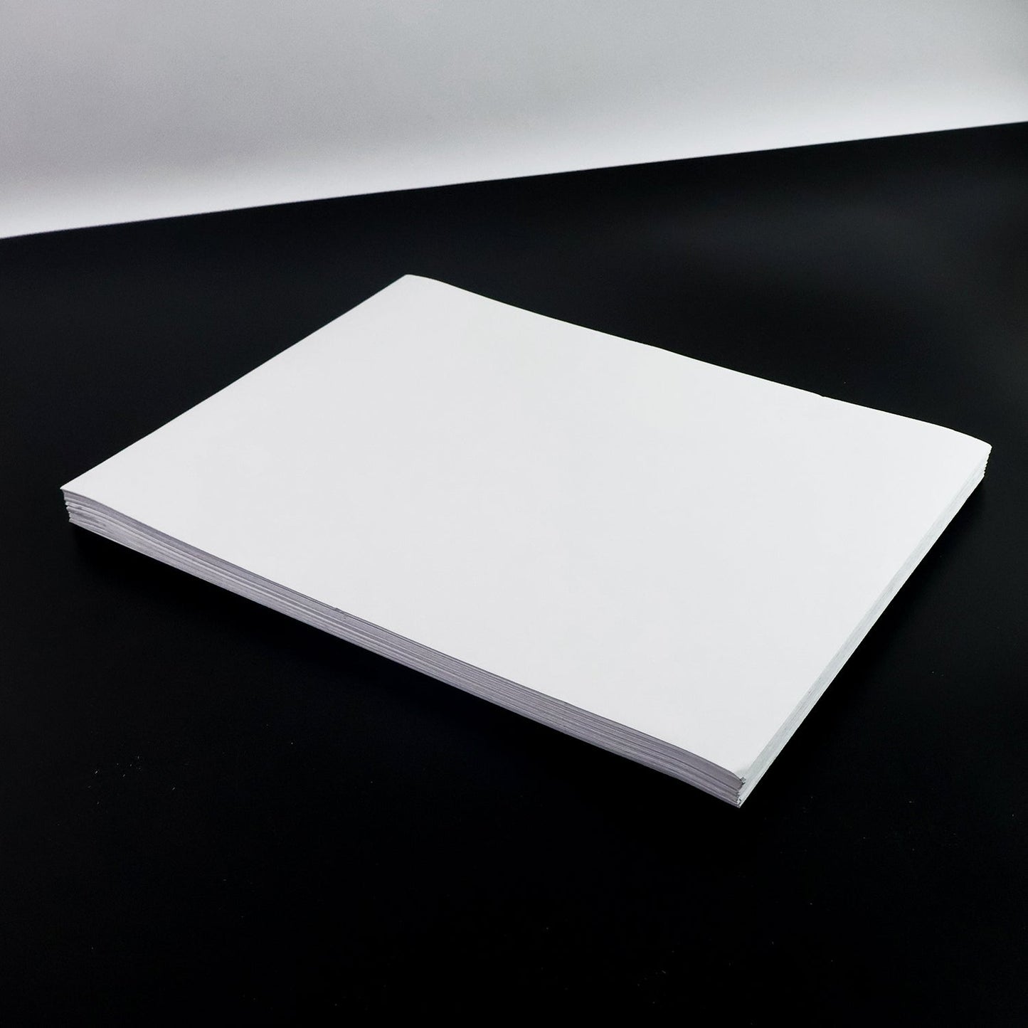 White A4 self-adhesive label sheets stacked neatly for printing