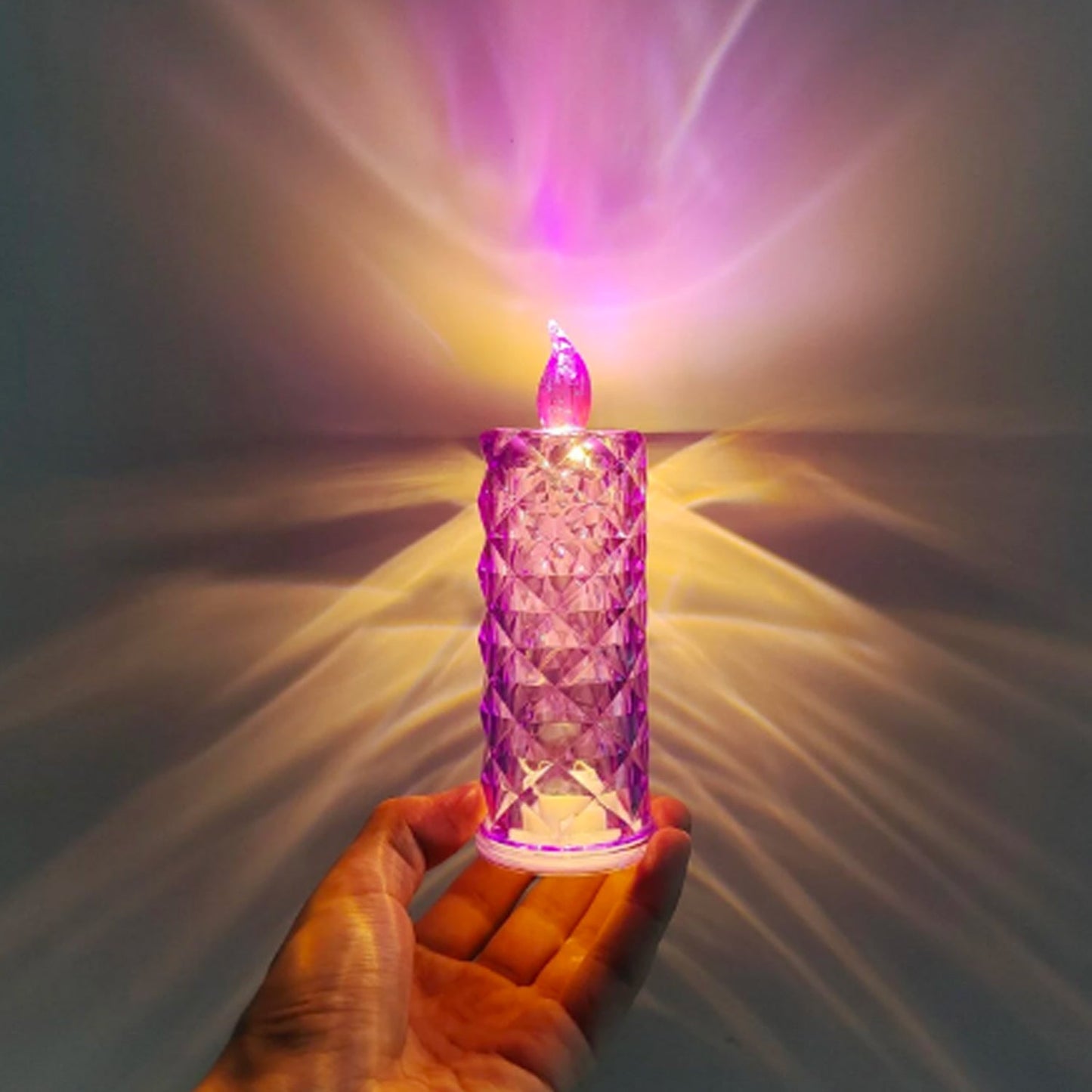 Close-up of glowing pink LED crystal candlelight showing swirling glitter effect