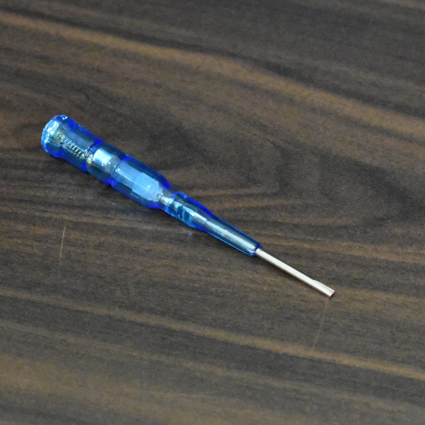 Durable metal screwdriver with a built-in voltage tester for various electrical applications.
