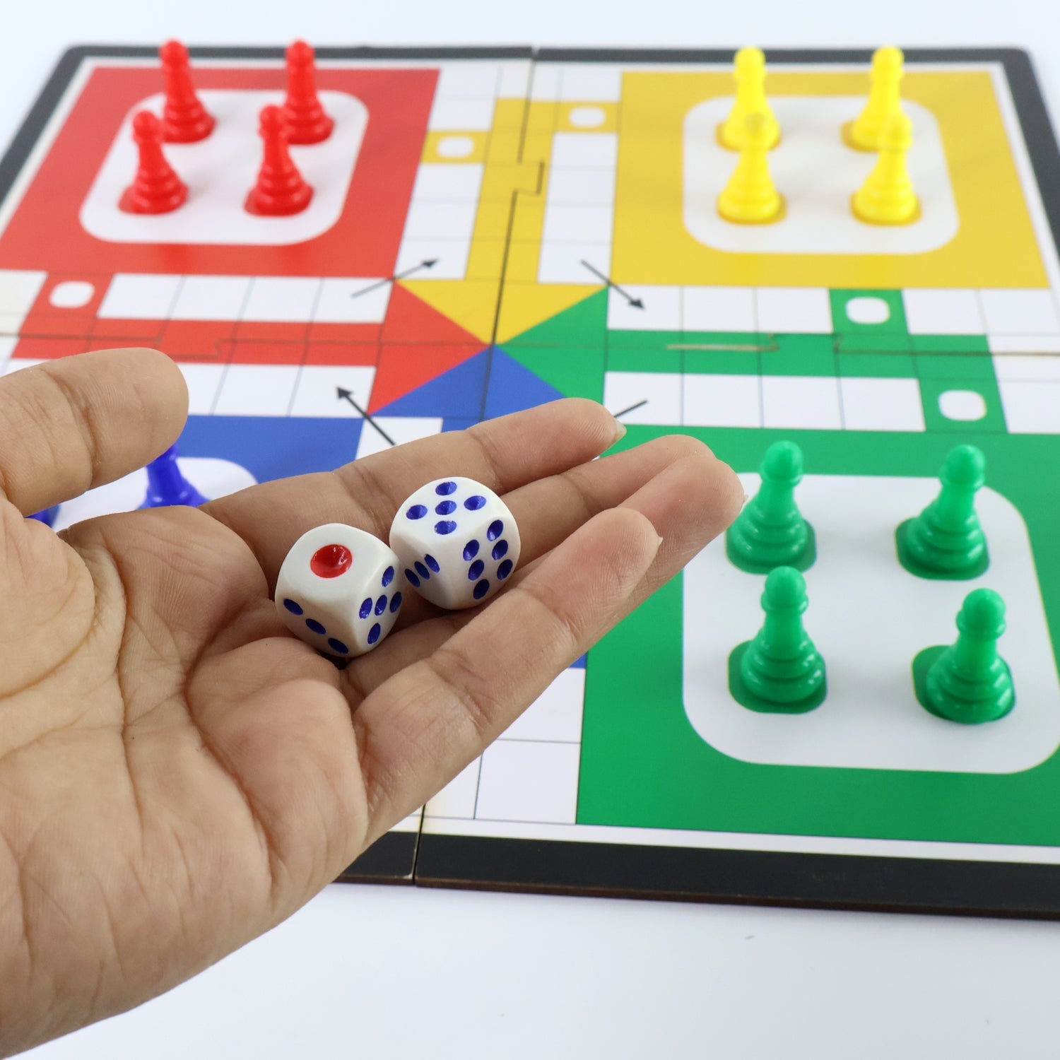 Children playing the portable Ludo board game together, enjoying family fun.