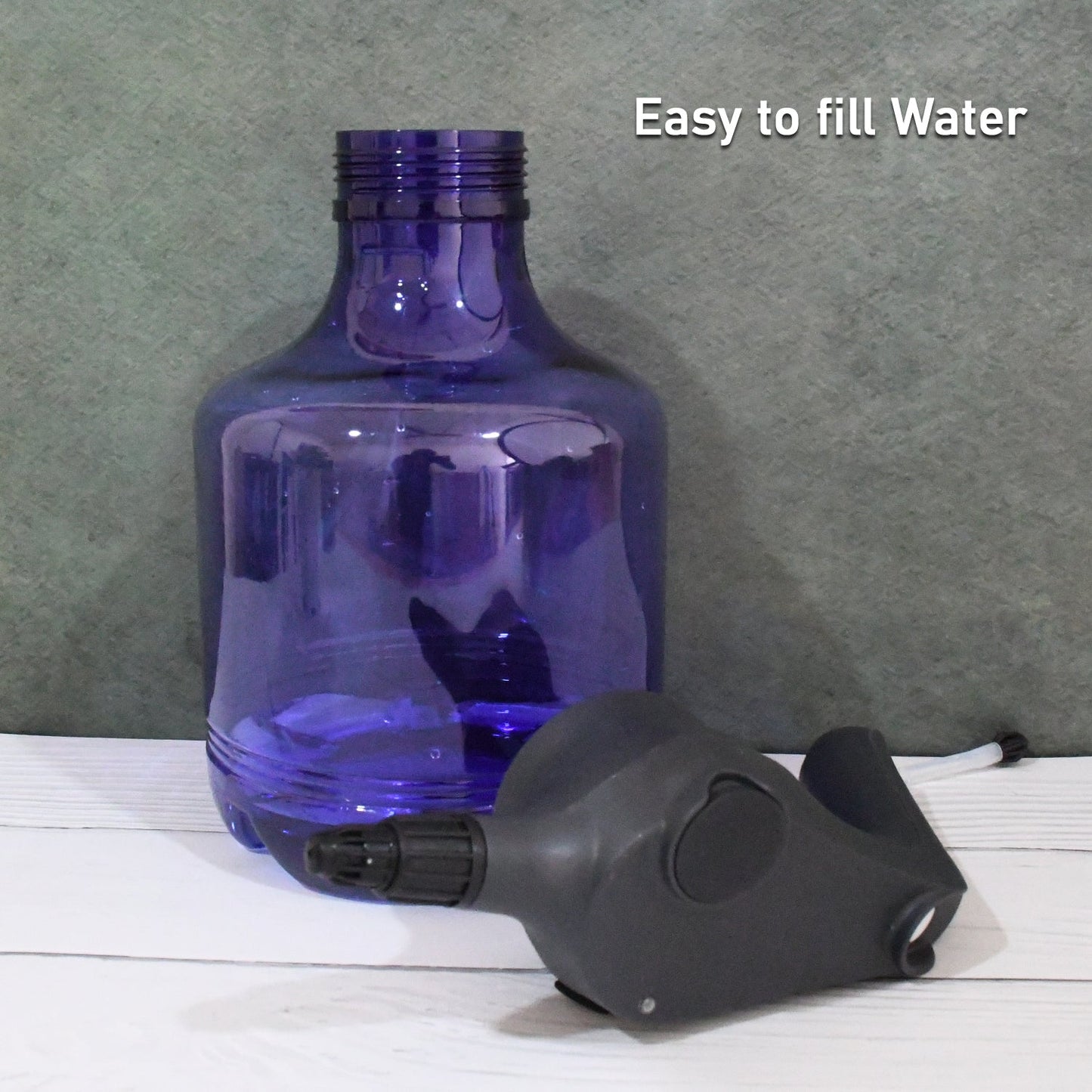 An electric garden sprayer gently misting a lush green plant for efficient and even watering.