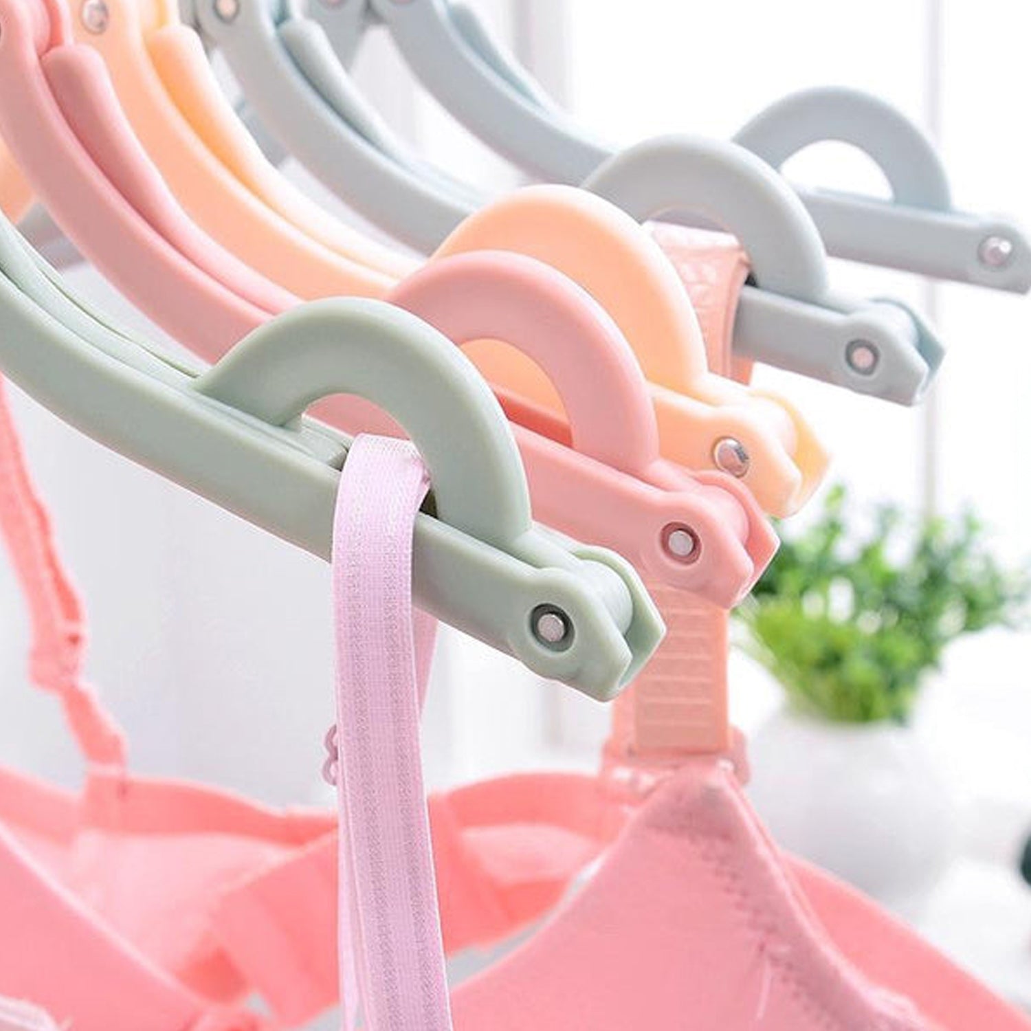 Travel-friendly clothes hangers, portable and foldable, presented as a 10-piece set.