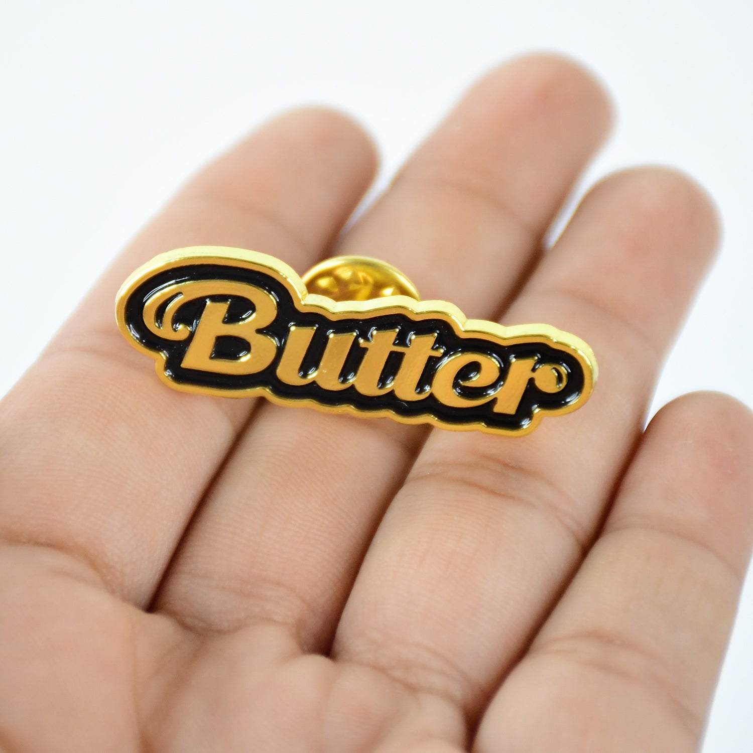 Back view of metal badge pin showing butterfly clutch for secure attachment