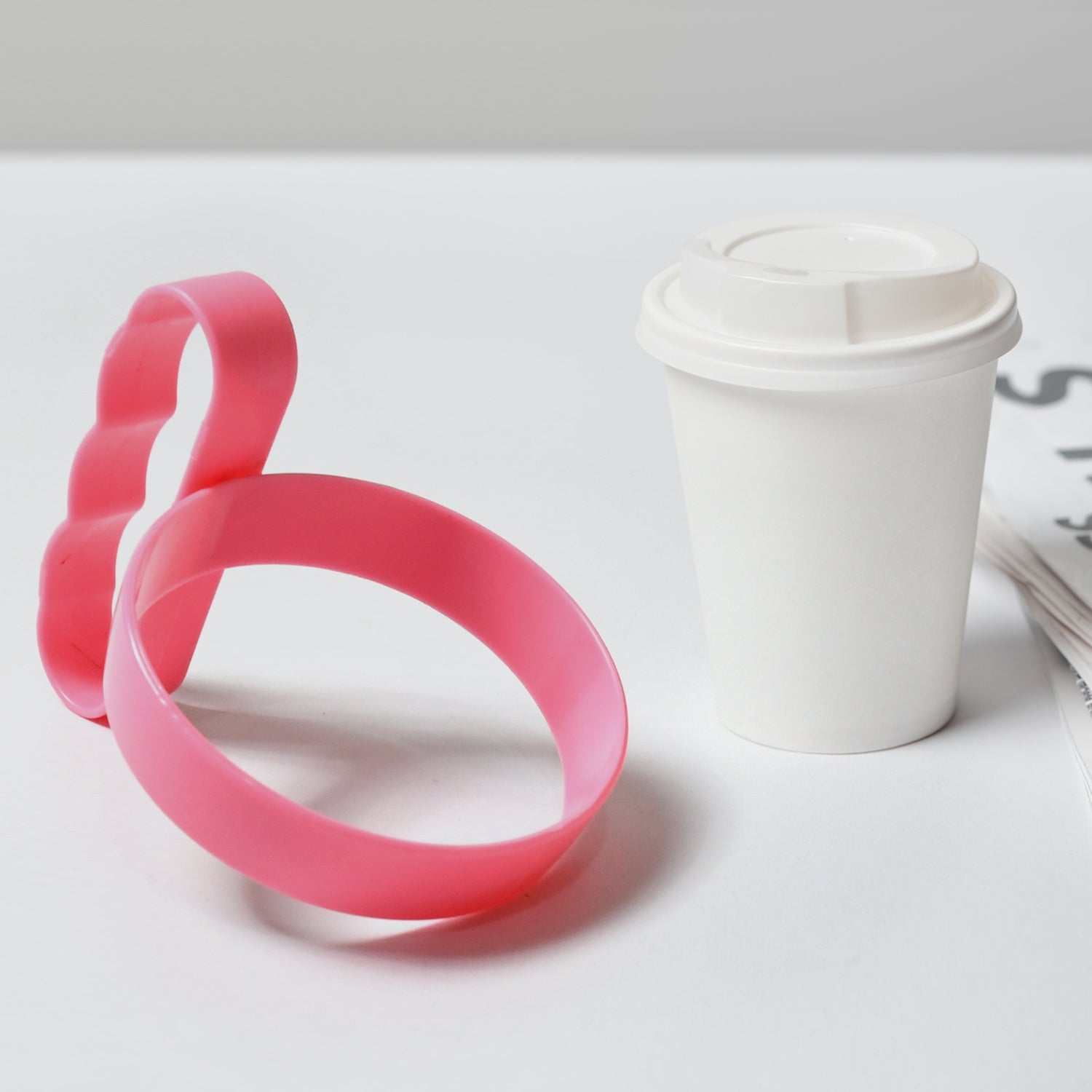 Lightweight tumbler handle attached to a mug, placed on a table for easy access.