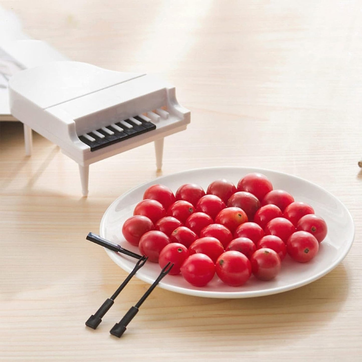Cute piano-style fruit forks adding a whimsical touch to a fruit platter, perfect for fun snacking.