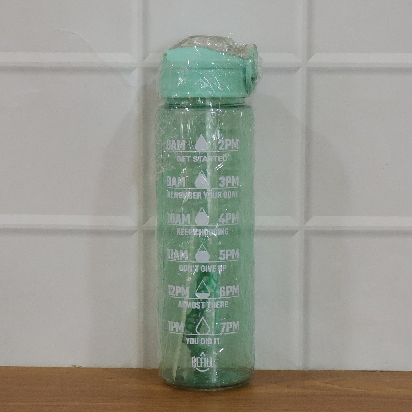 Water bottle displayed with gym and outdoor gear for active lifestyle