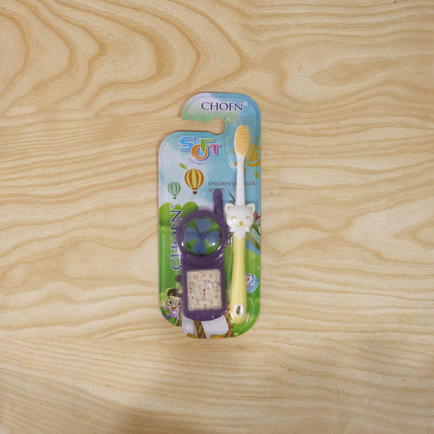 Overhead view of kids toothbrush set with fan toy