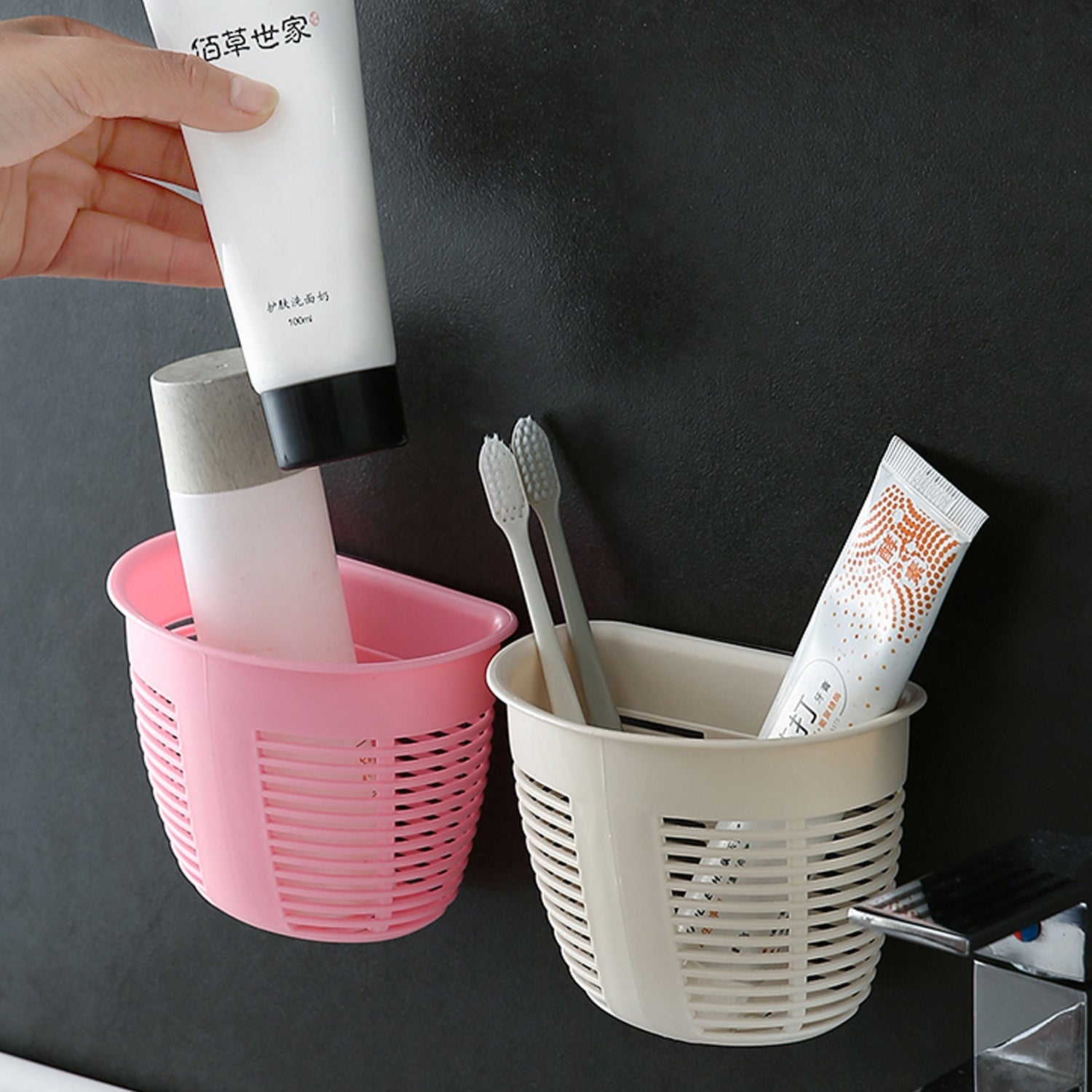 Hanging plastic storage basket in a modern bathroom, neatly holding shampoo and body wash.