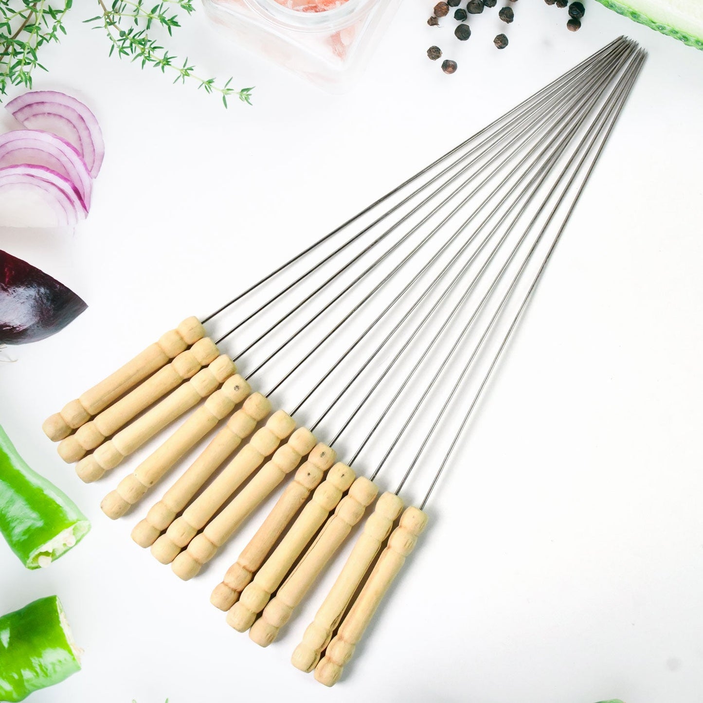 A complete set of 12 stainless steel BBQ skewers with comfortable wooden handles.