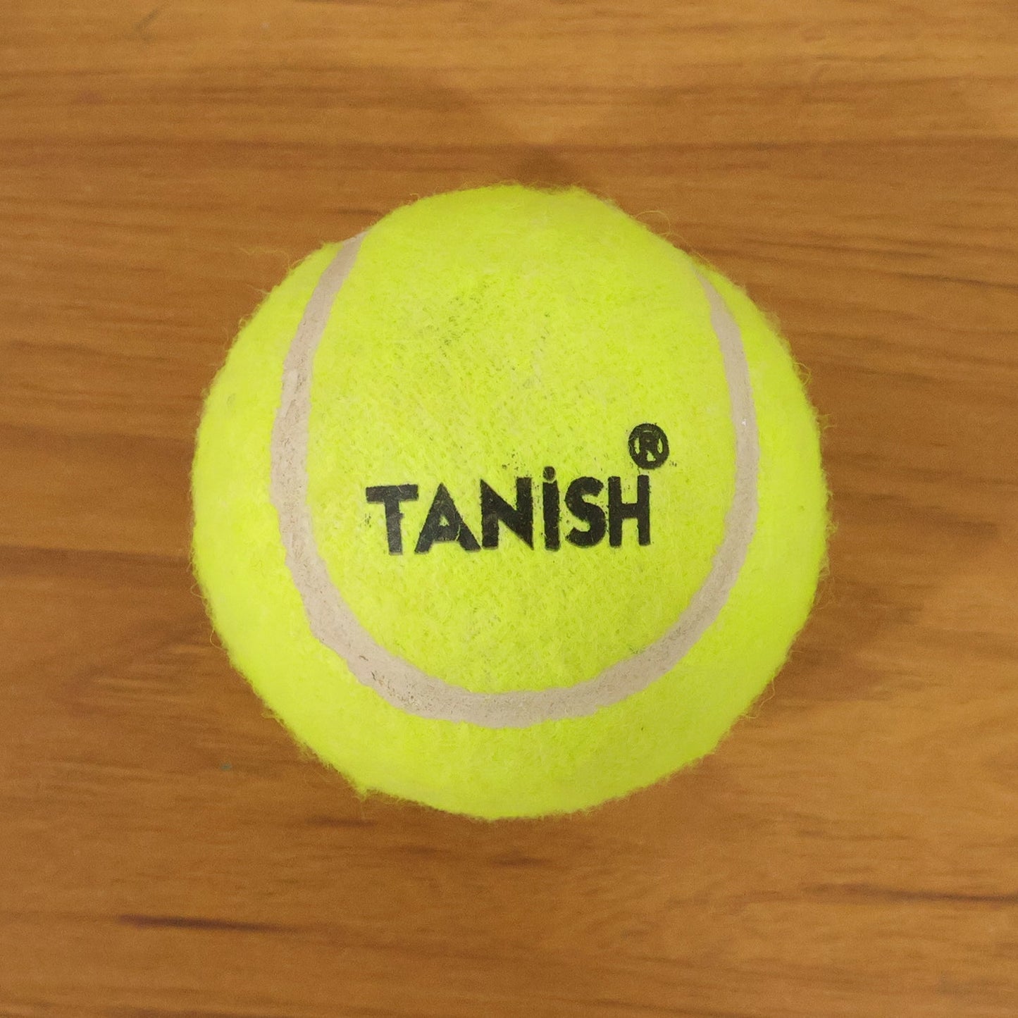 Tennis ball with bright color for easy visibility during outdoor games