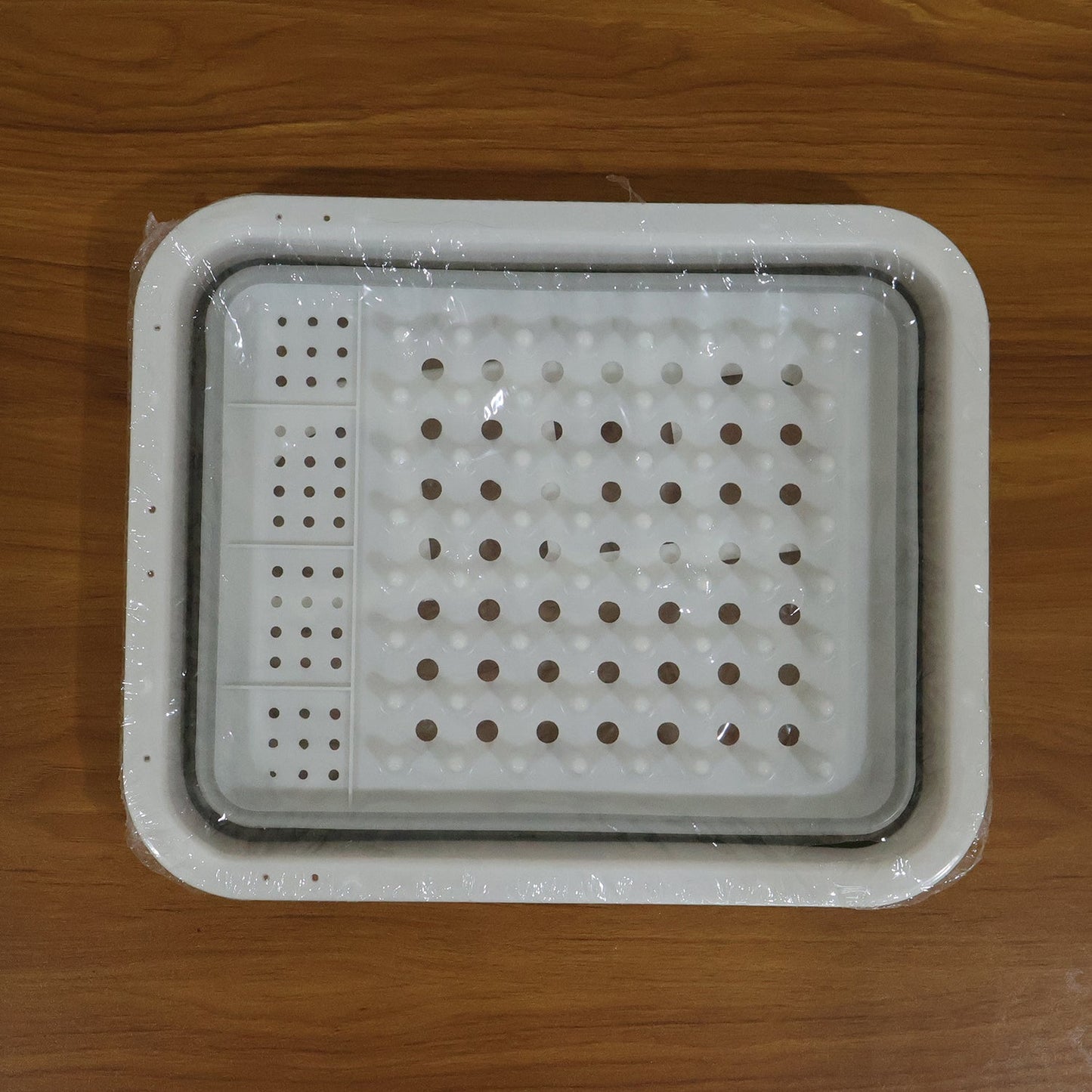 Foldable plastic dish drying rack on kitchen counter