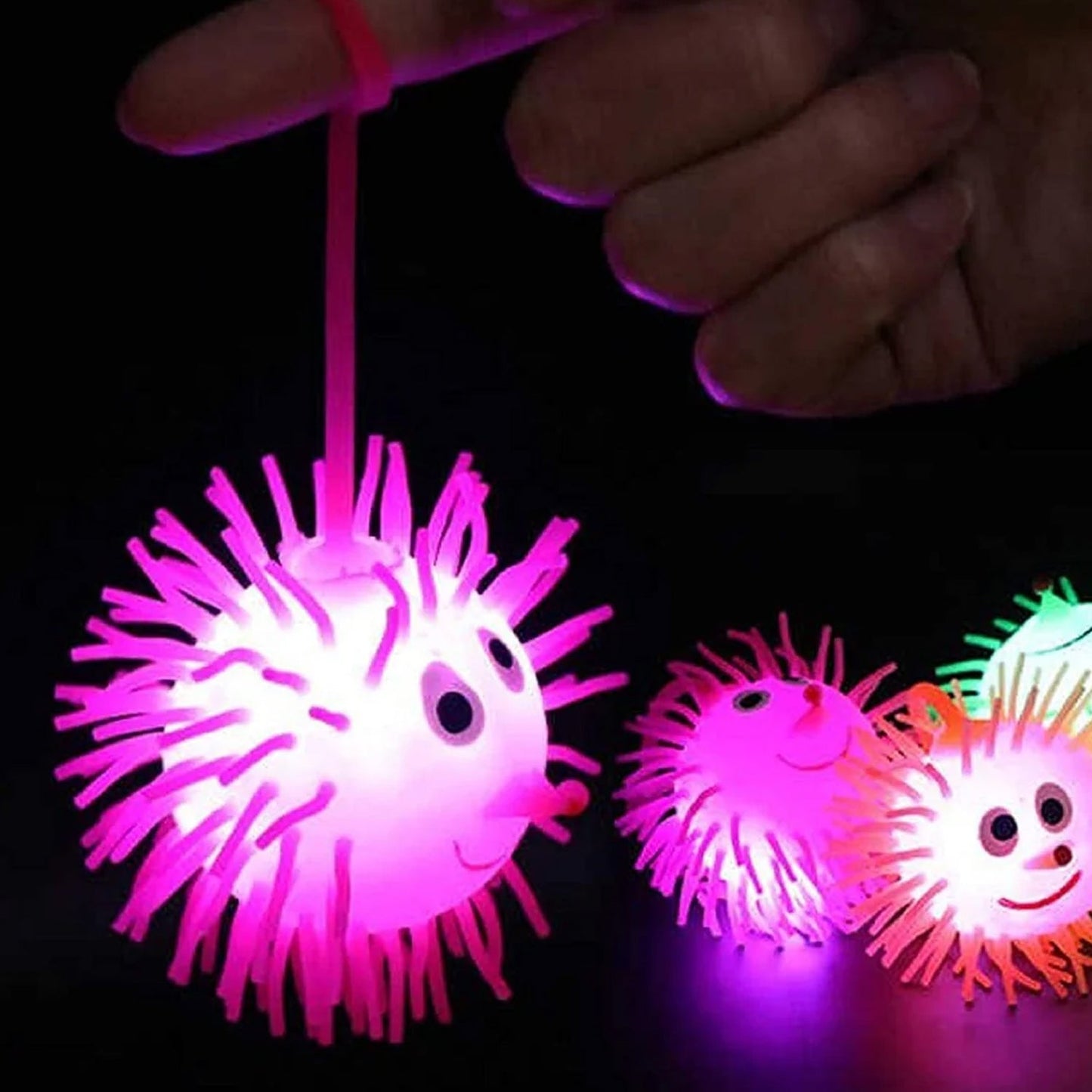 Child playing with LED light-up spiky ball toy