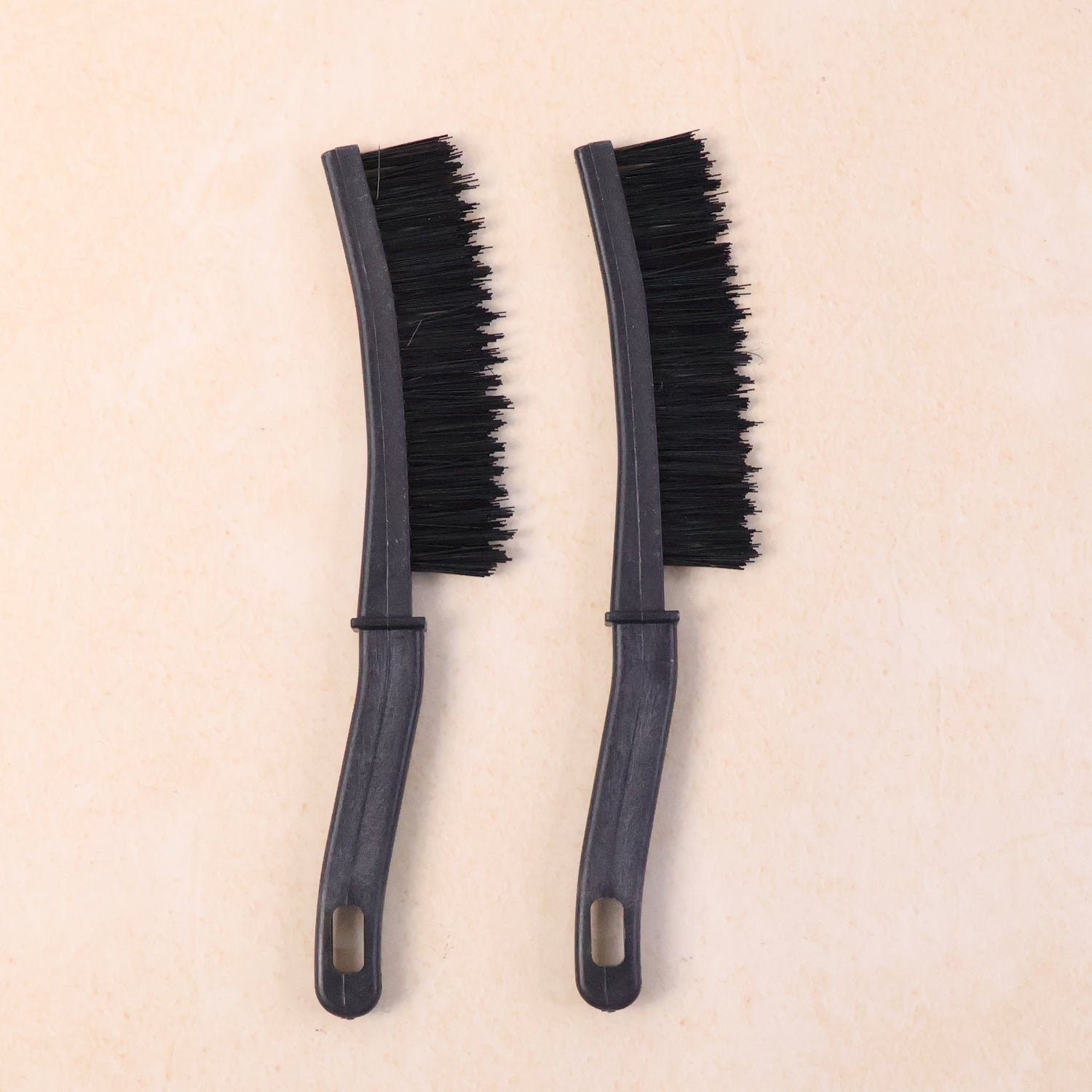 Close-up of long handle brush head cleaning narrow window track edges