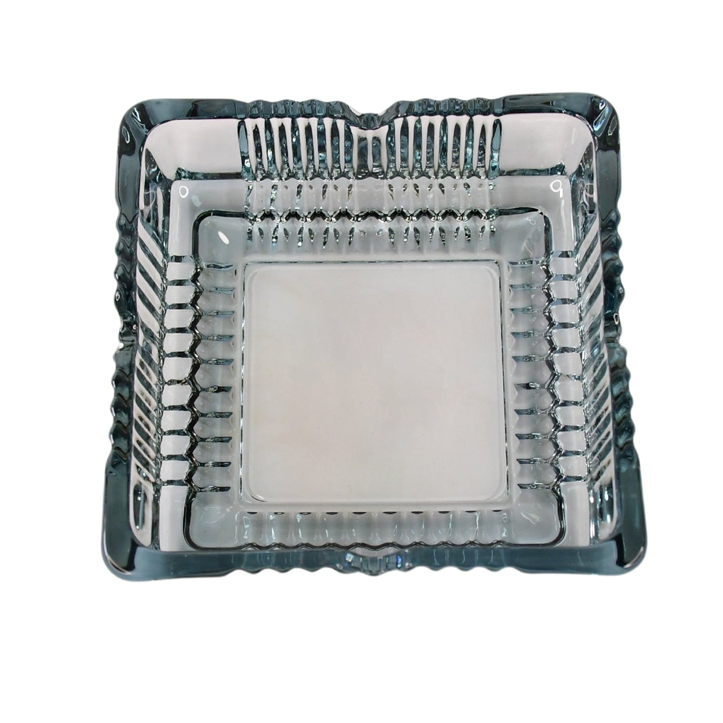 The elegant square glass ashtray displayed in a home or office setting.