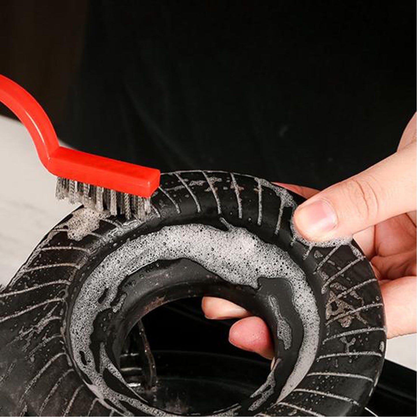 The versatile mini wire brush set effectively removing grime from a kitchen surface.