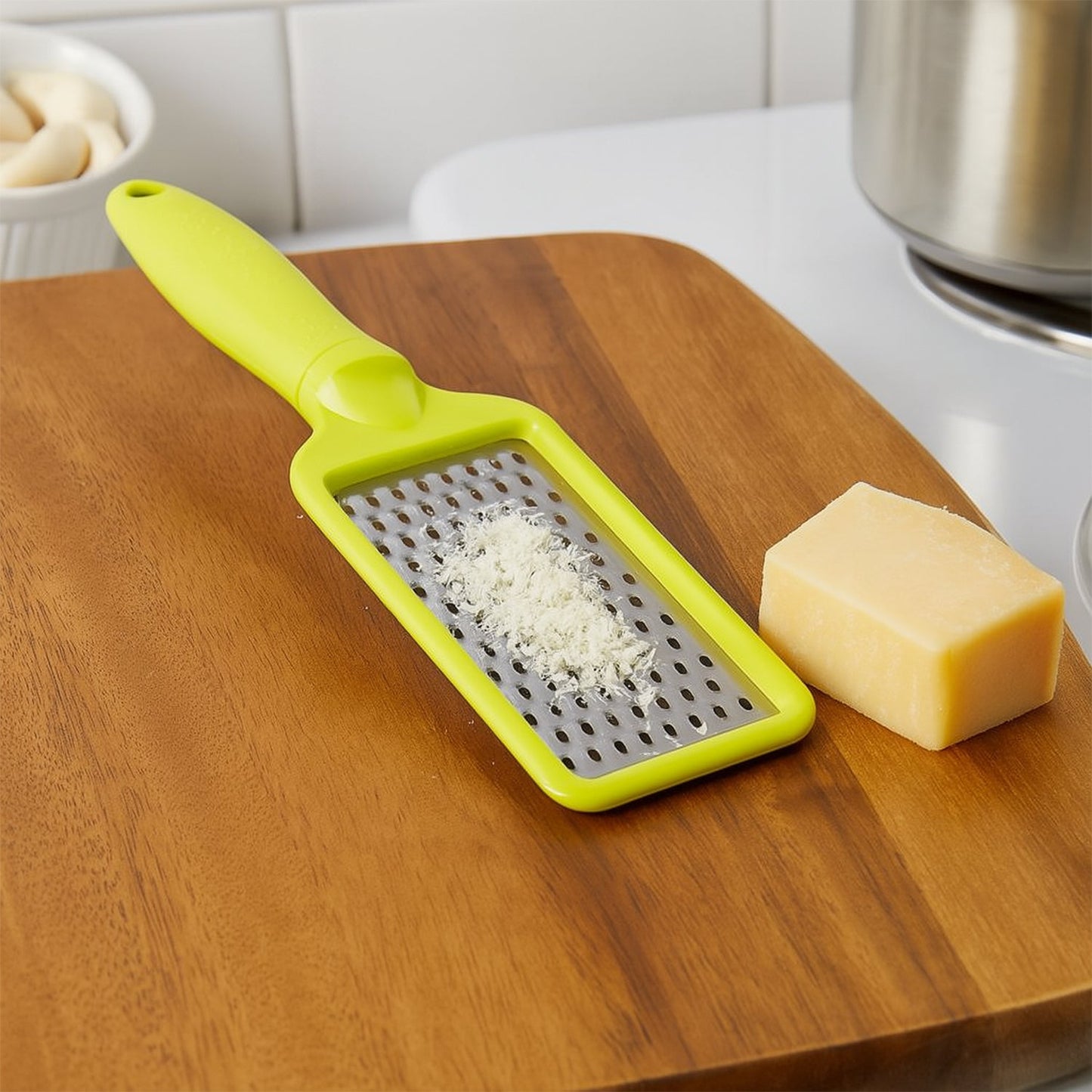 An overhead view of the CookAura grater, highlighting its full length and stainless steel blade.