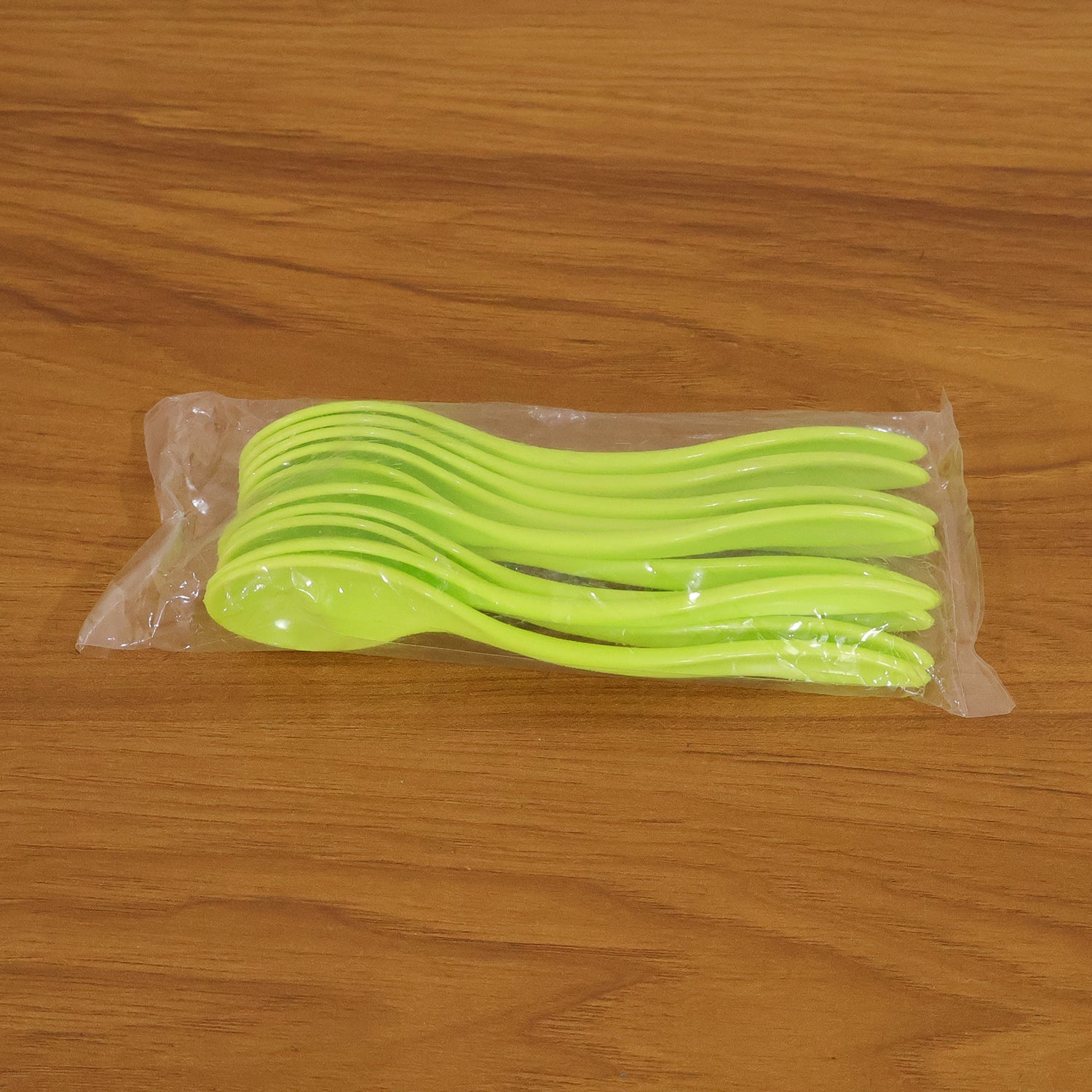 Collection of white plastic spoons arranged neatly, ready for use at any meal.
