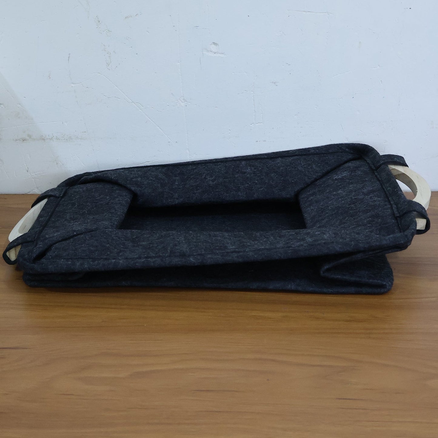 Folded pet toy storage basket, demonstrating its space-saving collapsible design.