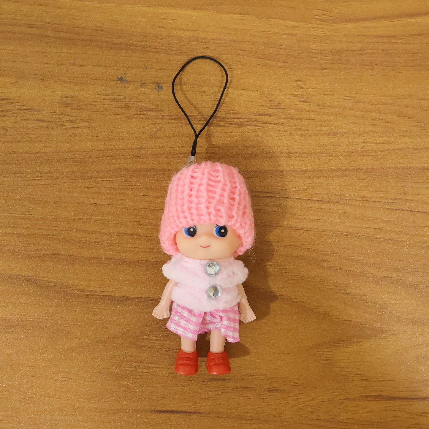 Vibrant outfit of mini doll keychain in colorful setting