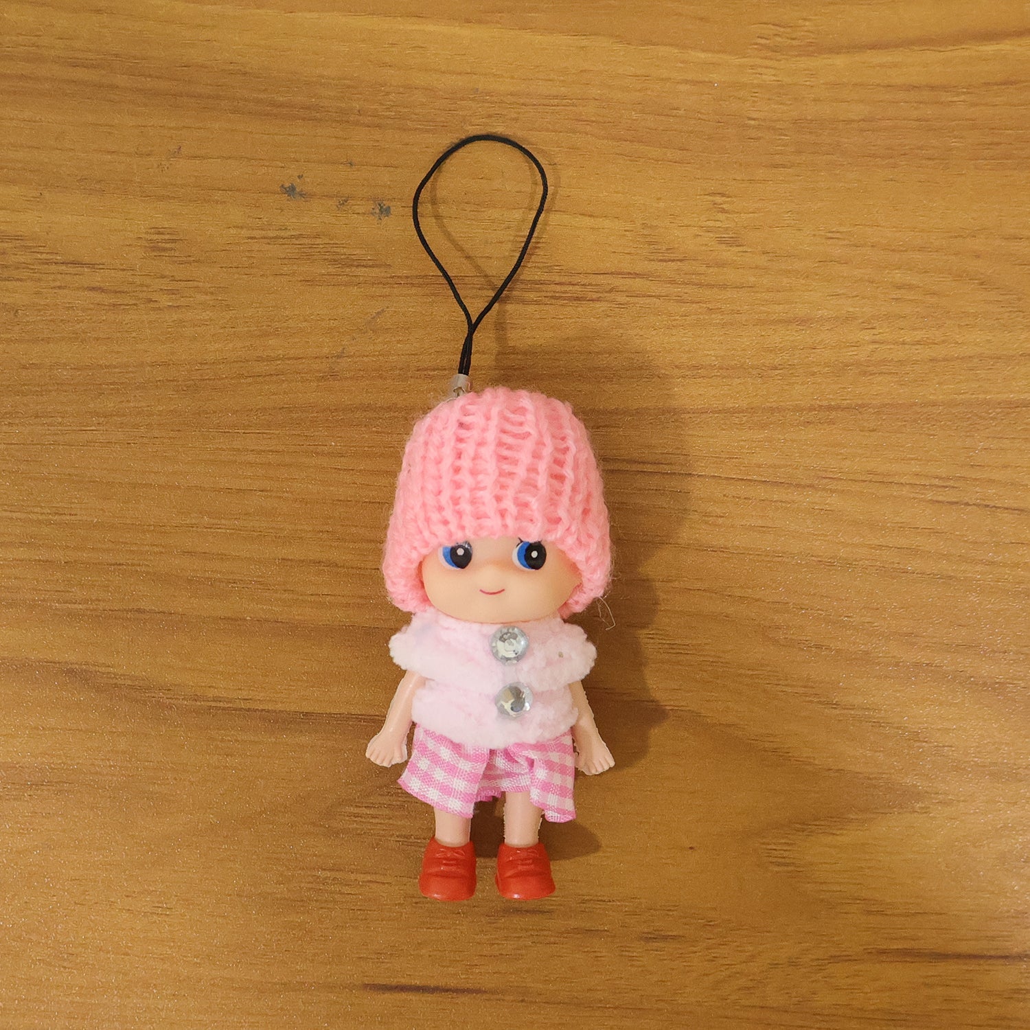 Vibrant outfit of mini doll keychain in colorful setting