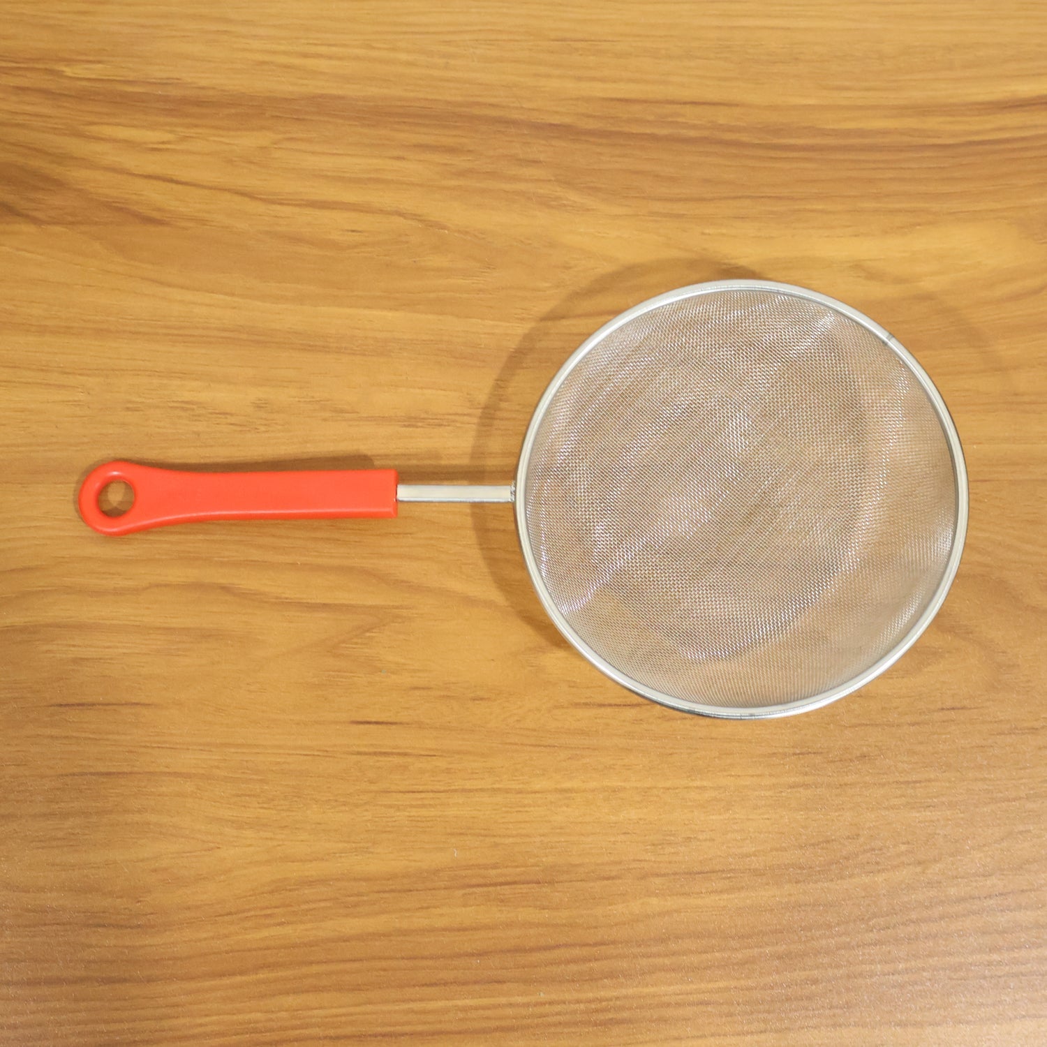 Close-up of fine mesh kitchen strainer's strong grip handle