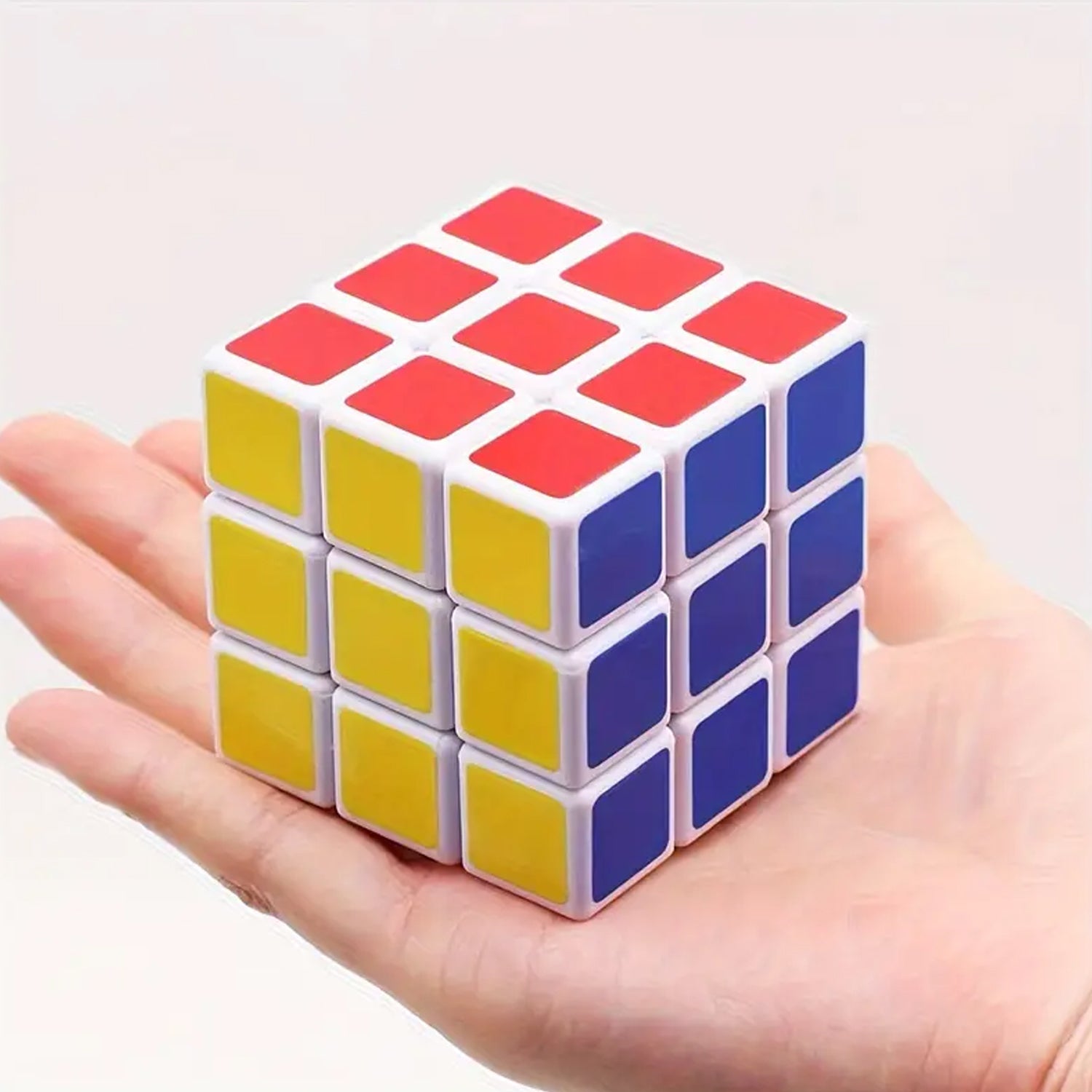 An adult engaging with a Rubik's Cube, using it as a fun brain teaser and stress-relieving logic puzzle.