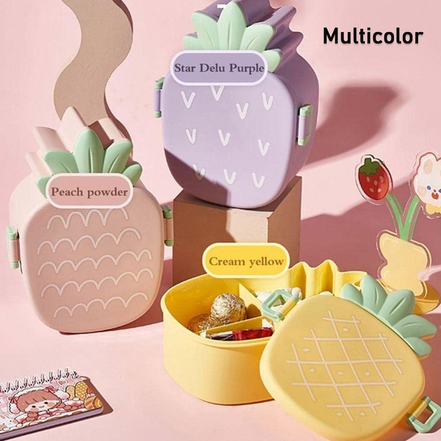 Pineapple kids lunch box with fork and spoon placed neatly inside a child's lunch bag.