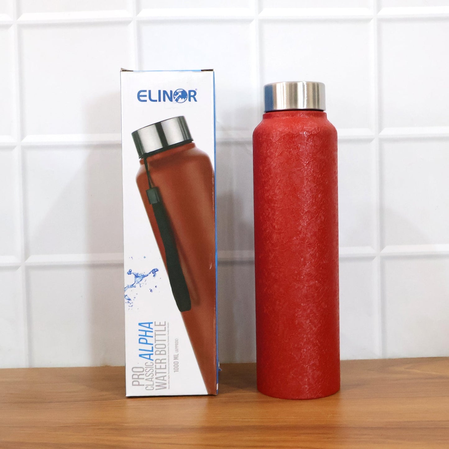 Red stainless steel water bottle in natural light highlighting design