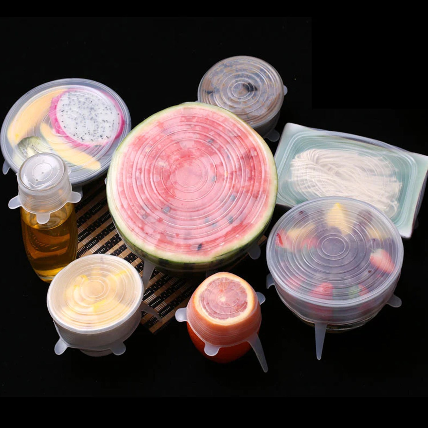 Flexible silicone food covers stretched over different container sizes