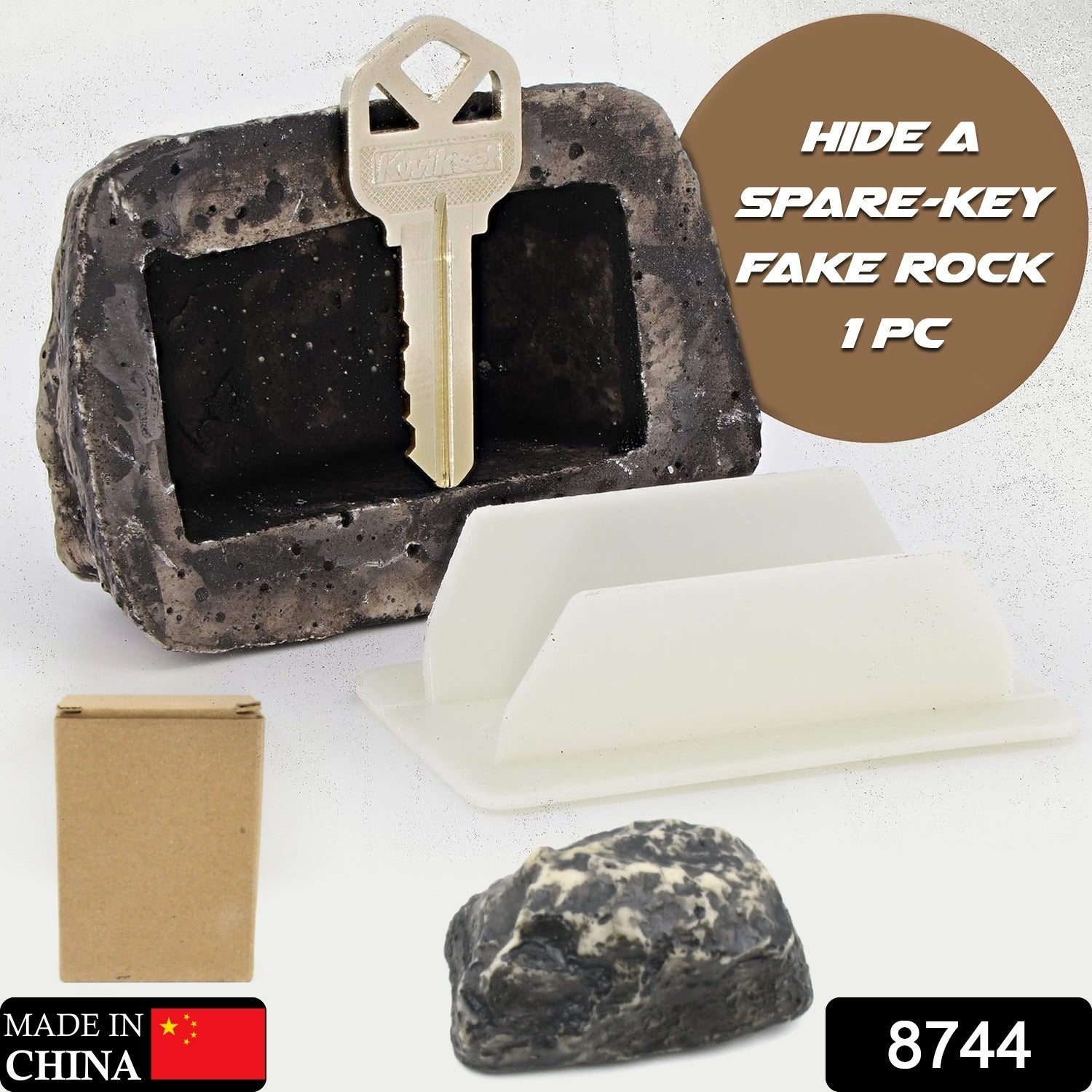 Open fake rock key hider revealing the hidden compartment for a spare key.