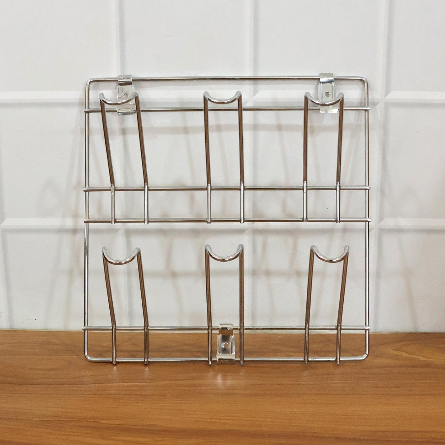 Close-up of stainless steel wall-mounted mug and cup holder rack