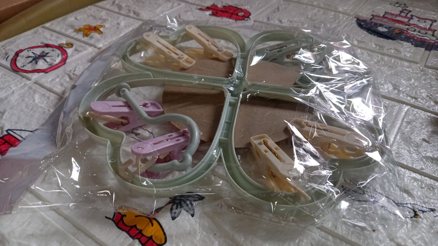 Heart-shaped clothes hanger with 8 clips for efficient drying.